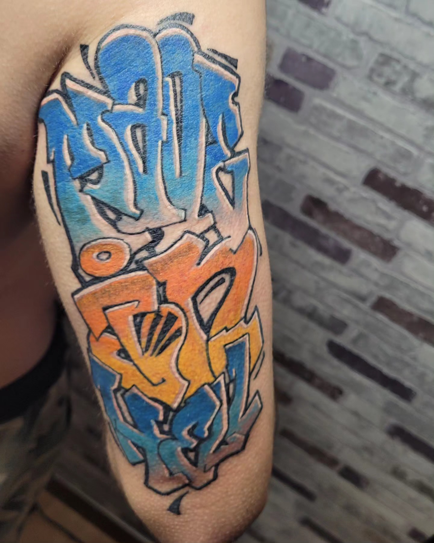 Graffiti-style lettering new school tattoo on the forearm by Gonzalo Pantona