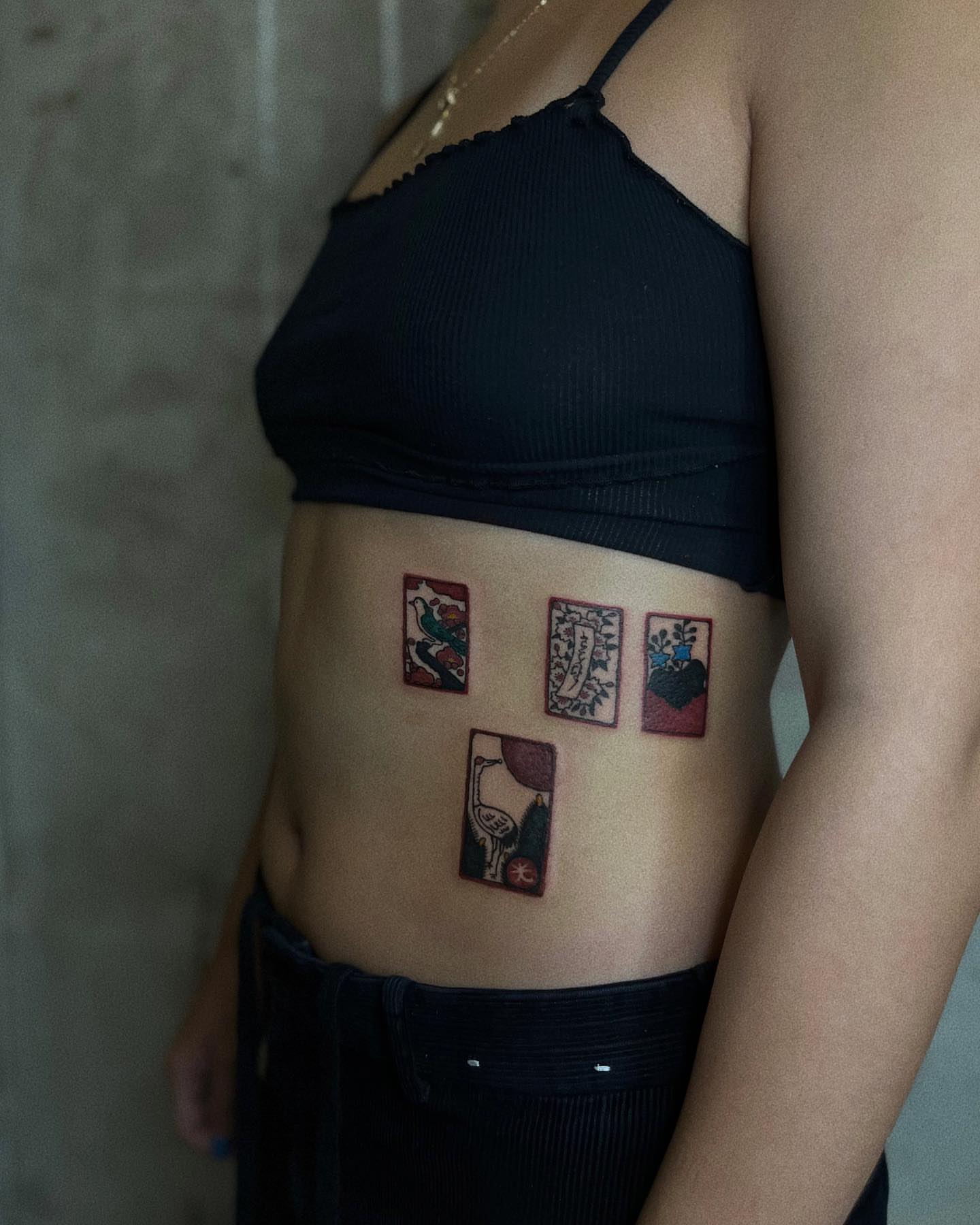 Tarot cards American traditional tattoo on the torso by San Kang