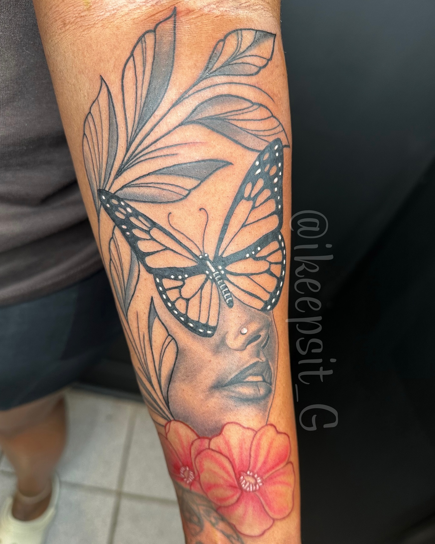 Woman's face with butterfly and flowers realism tattoo on the forearm by Prolific🏁so Gifted