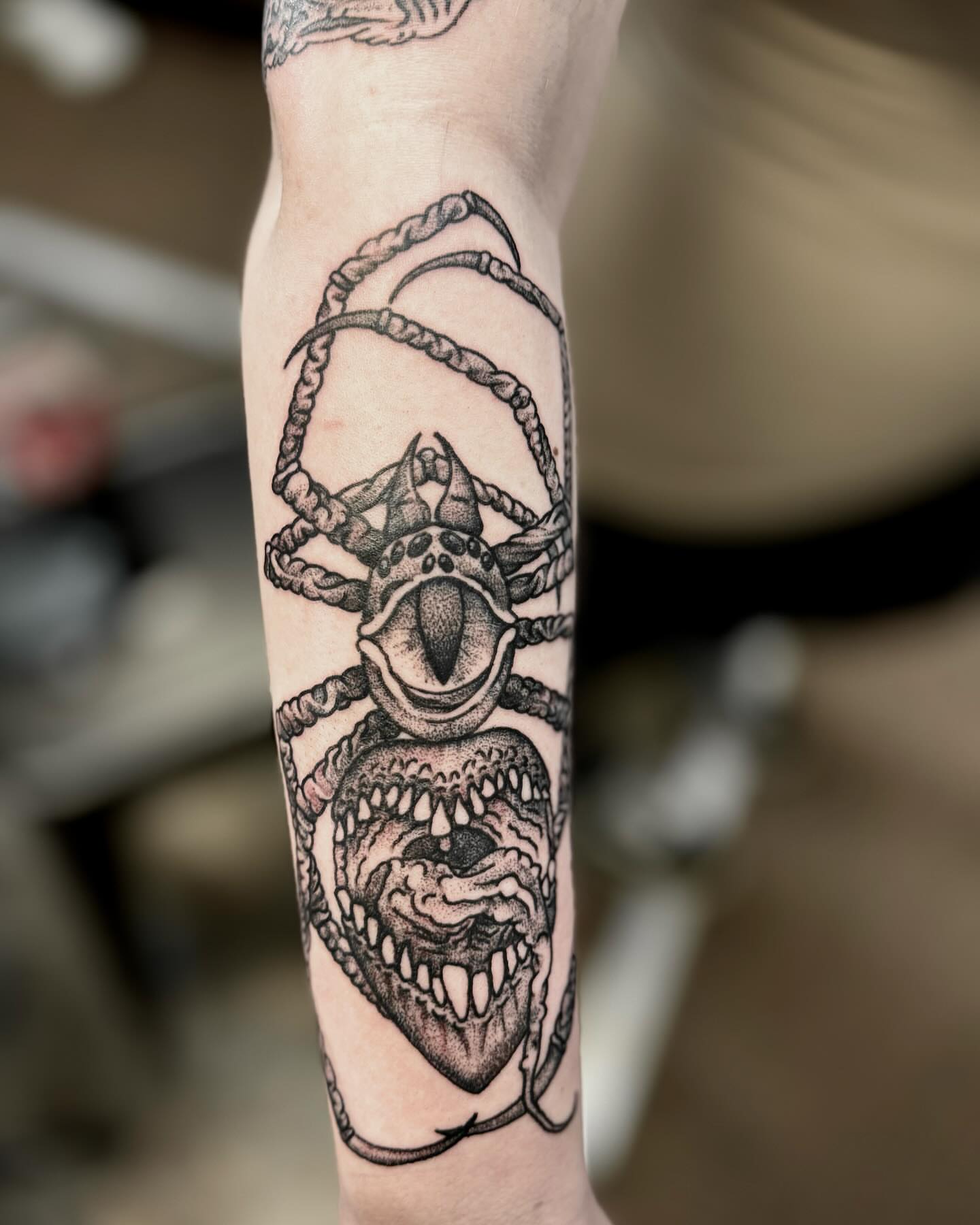 Demon head black and grey tattoo on the forearm by William Worley