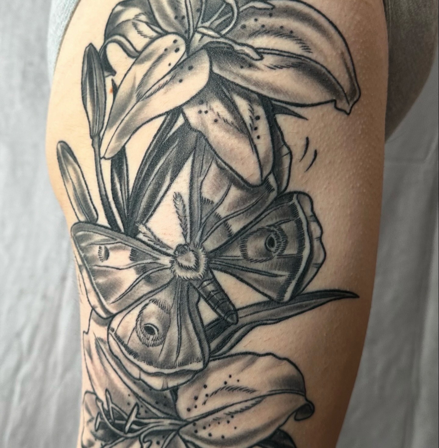 Lily and butterfly realism tattoo on the forearm by ✨Sarah Knapp✨, Eugene, Oregon
