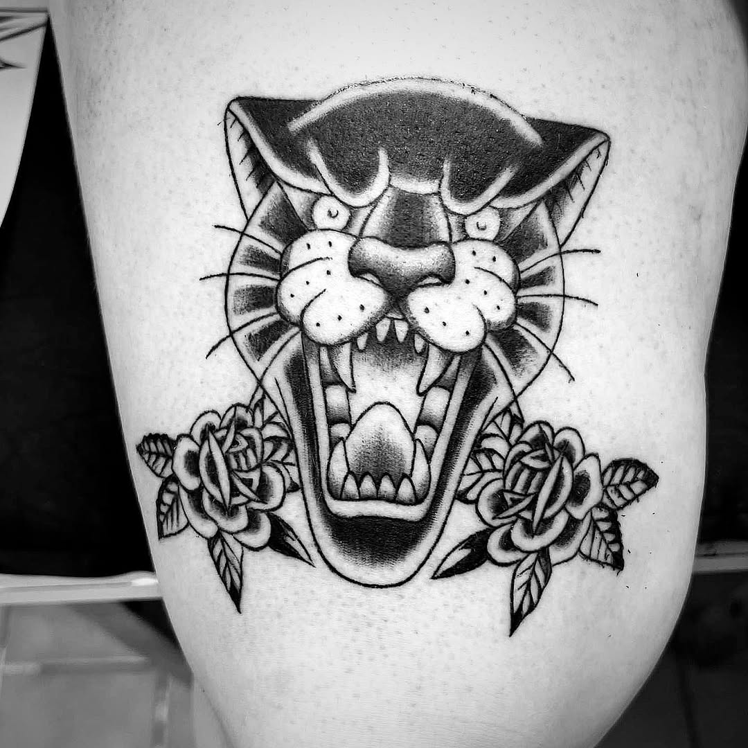 Panther head with roses realism tattoo on the thigh by Bear