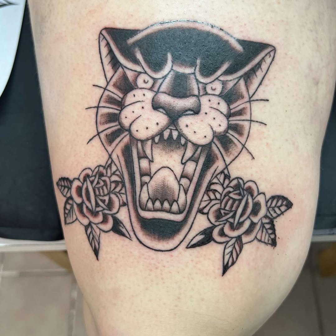 Panther head with roses realism tattoo on the thigh by Bear