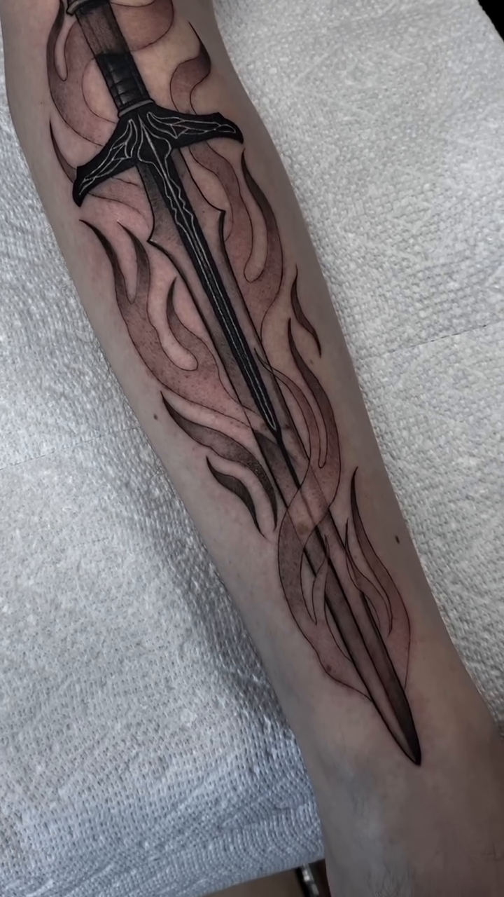 Sword with flames realism tattoo by Marissa Tattoos