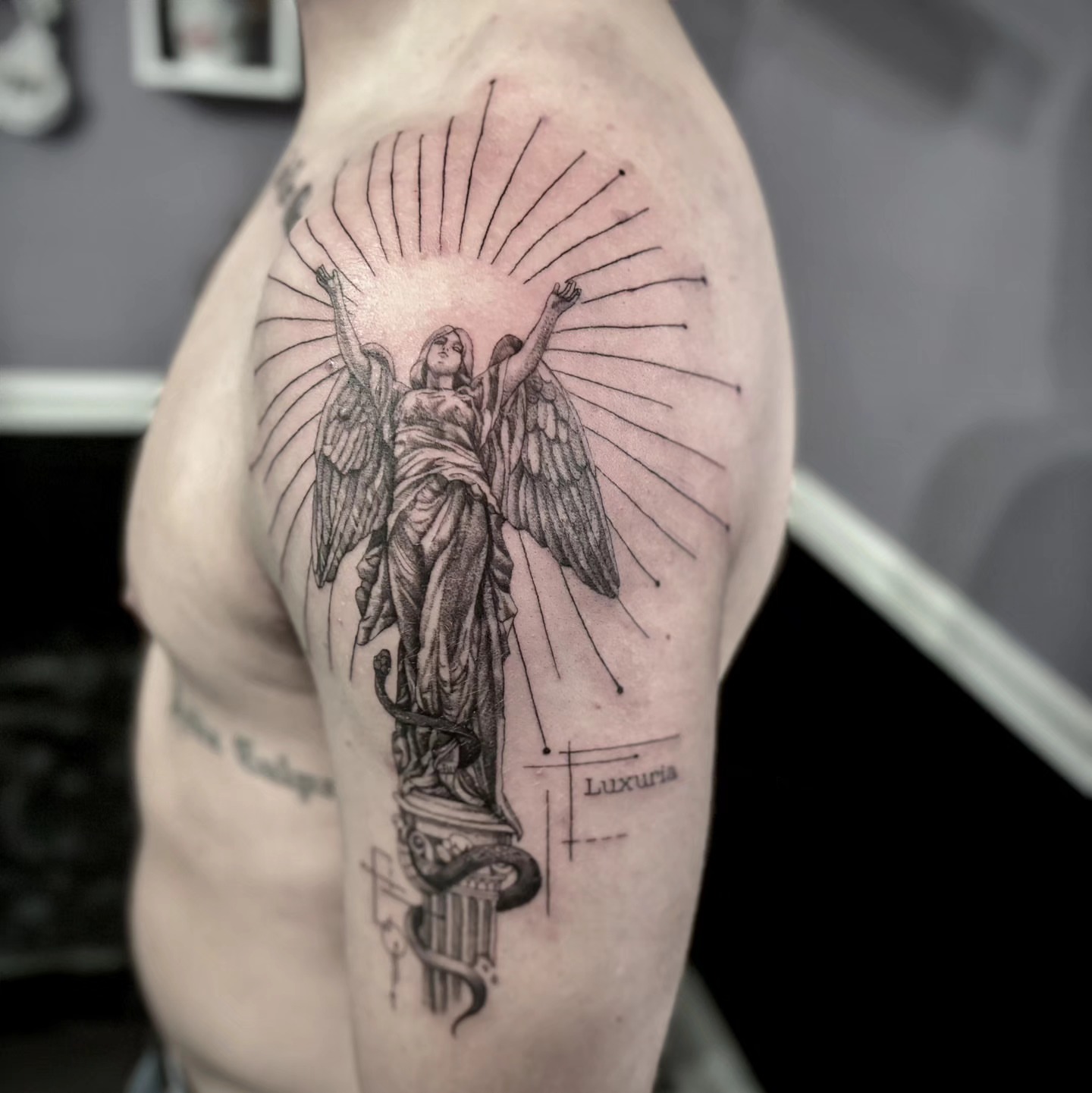 Statue with wings realism tattoo on the shoulder by Utah Tattoo Artist