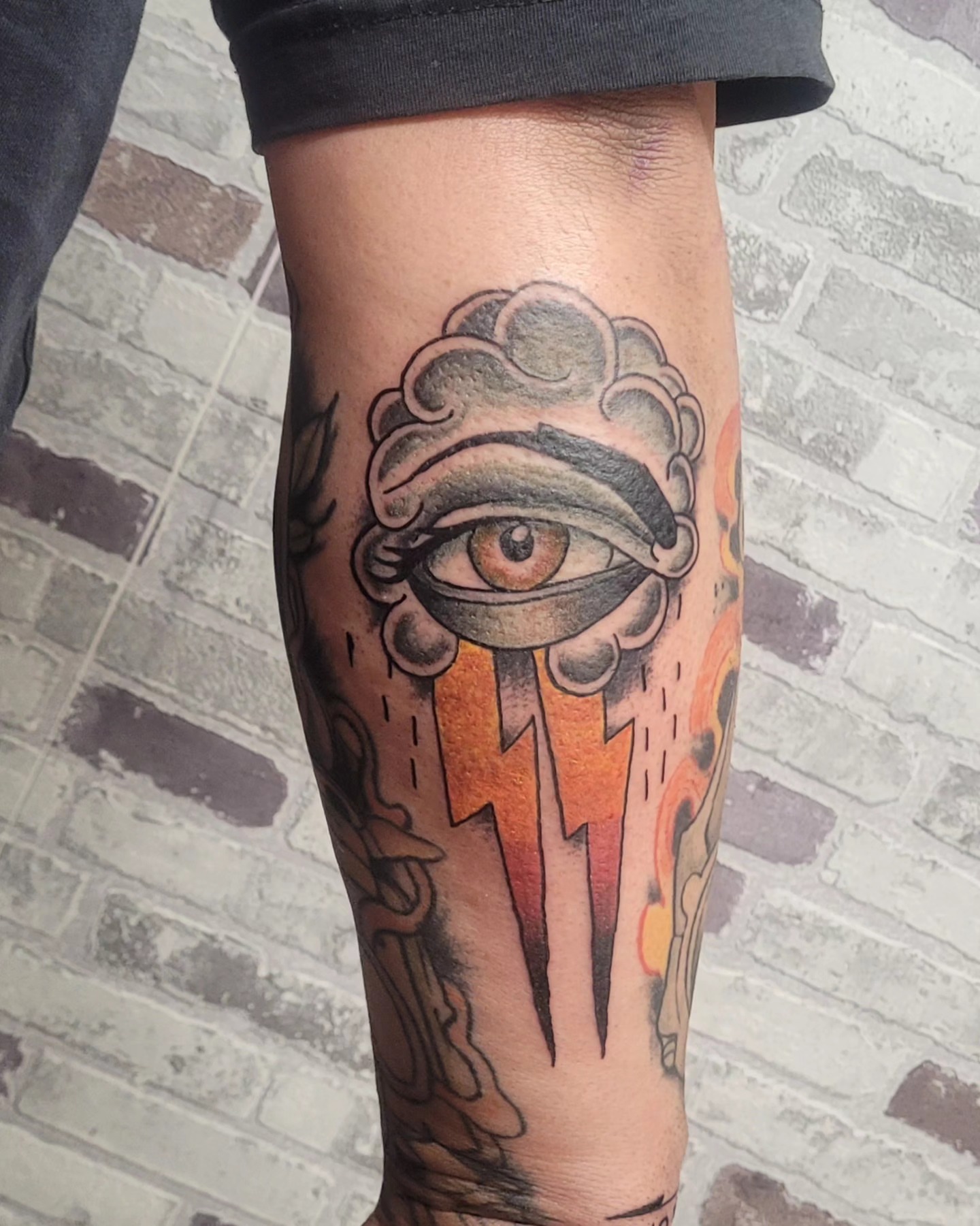 Eye with cloud and lightning American traditional tattoo on the forearm by Gonzalo Pantona