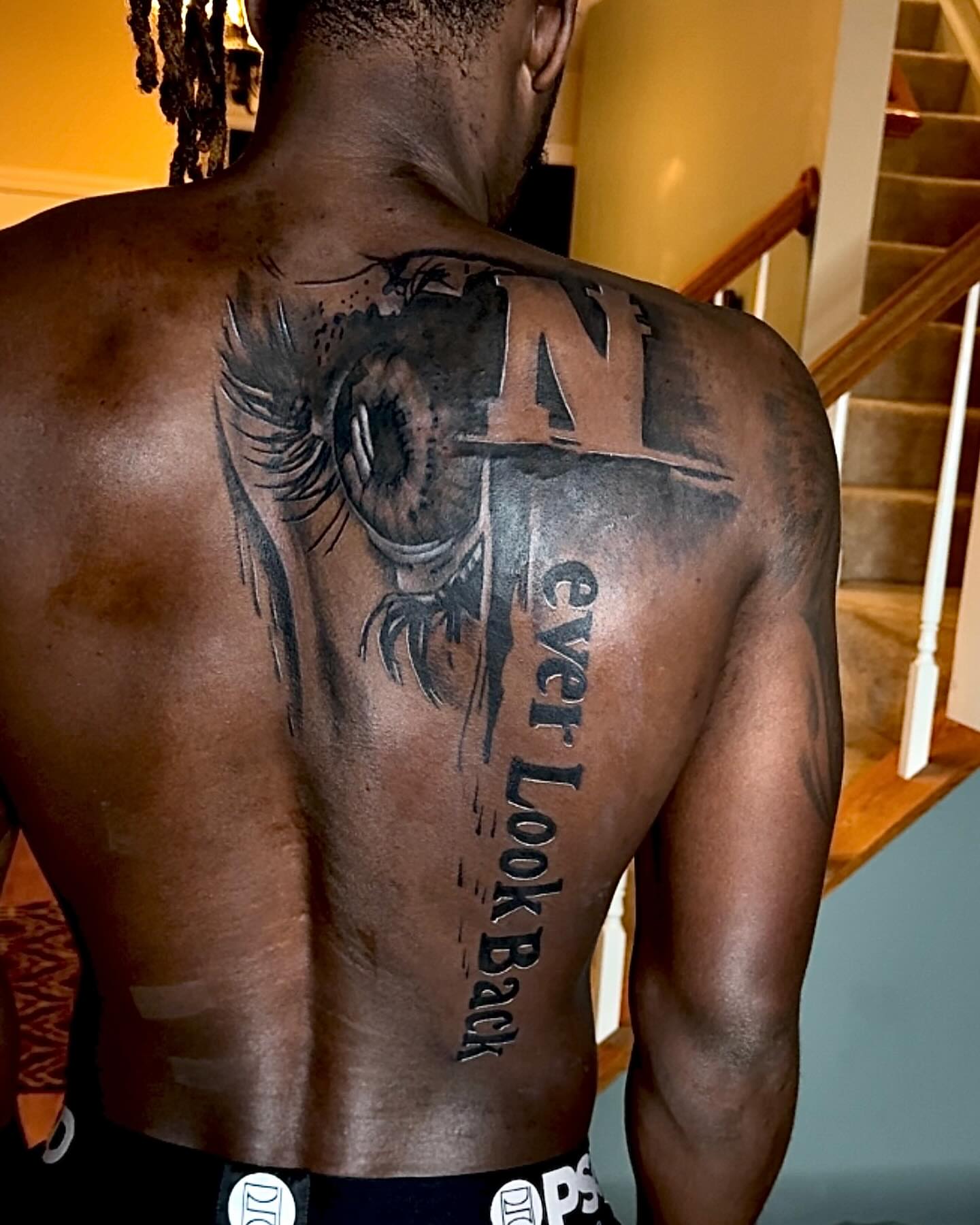 Eye and text realism tattoo on the back by Tatt2T (T King)