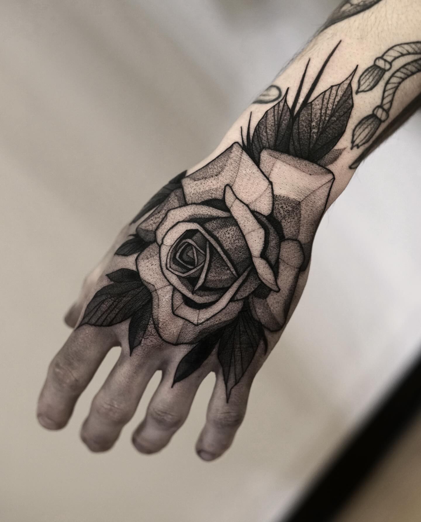 Rose realism tattoo on the hand by Max LaCroix