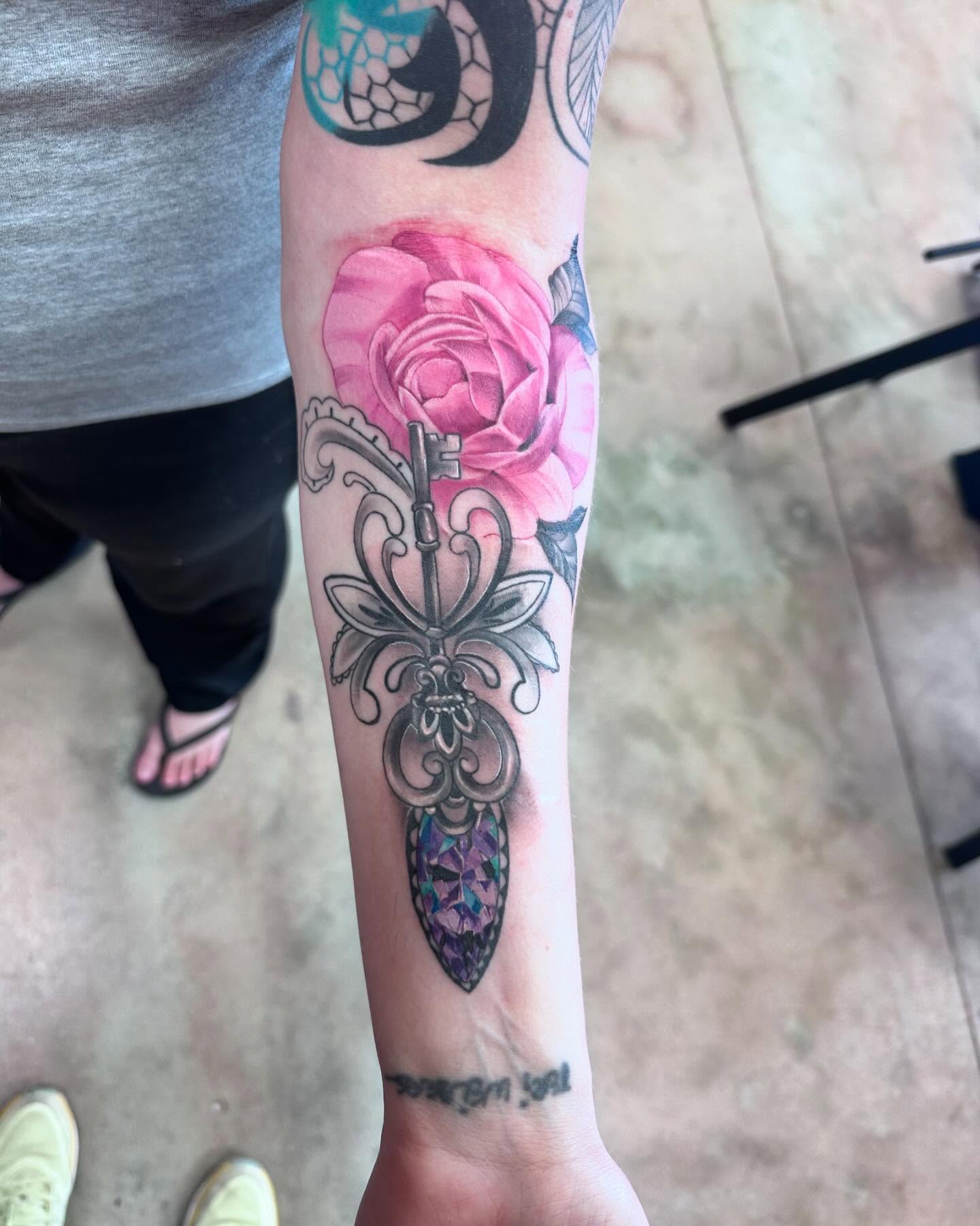 Key and rose new school tattoo on the forearm by Shawn Cook
