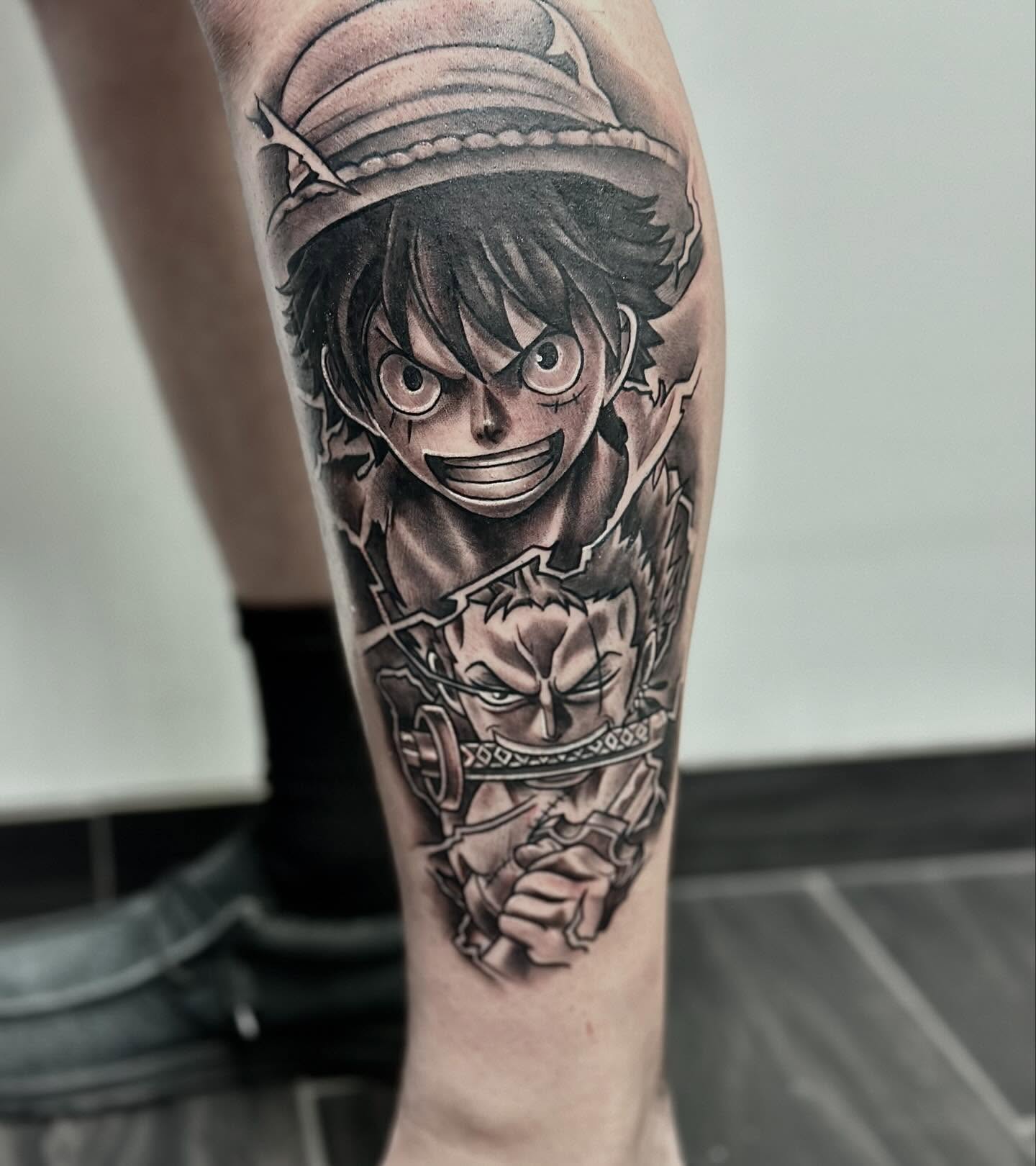 Anime character anime tattoo on the forearm by Aaron Watson