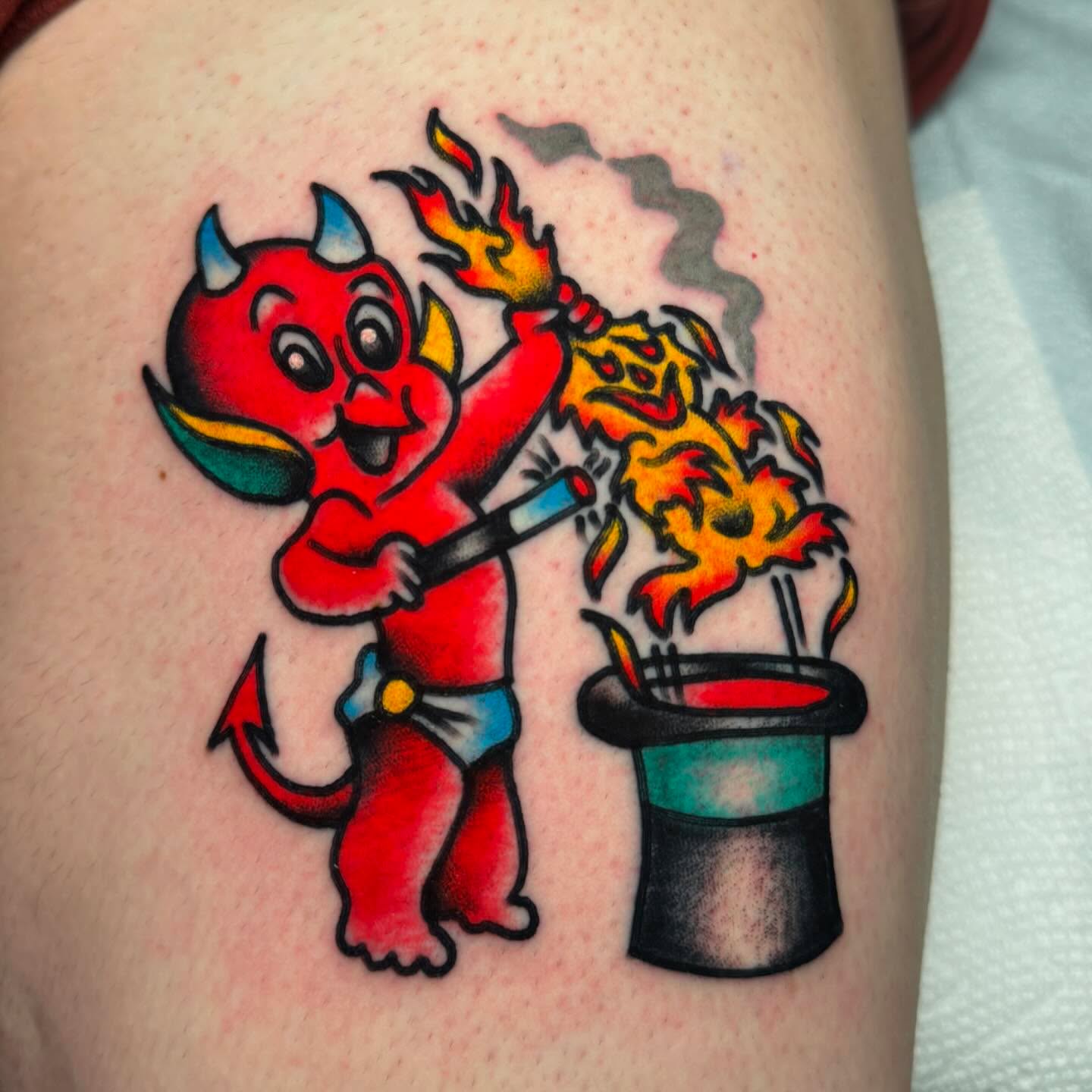 Devil with fire American traditional tattoo on the thigh by Stevie Lowenstein, Cincinnati, Ohio
