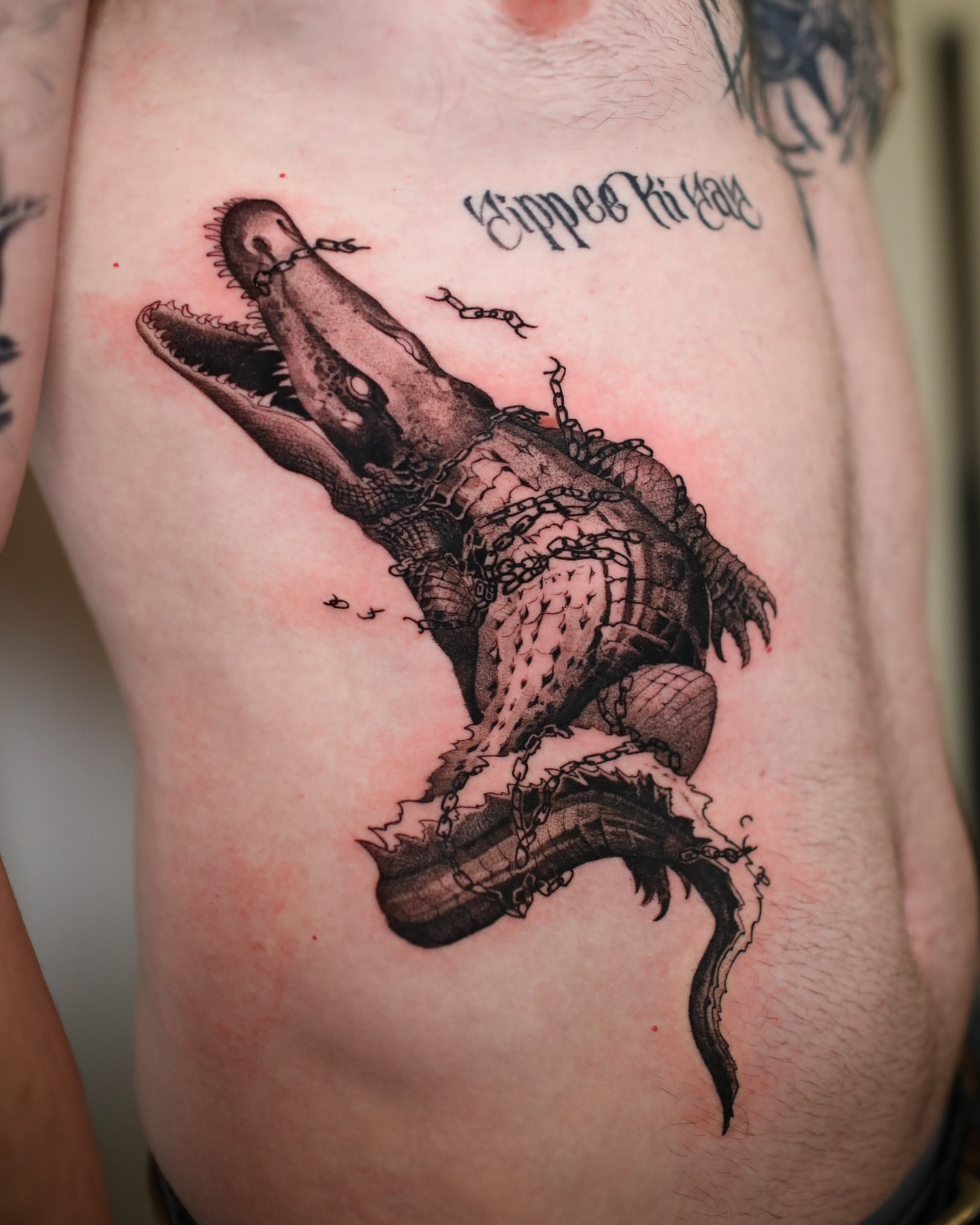 Alligator realism tattoo on the thigh by Strokin Konstantin