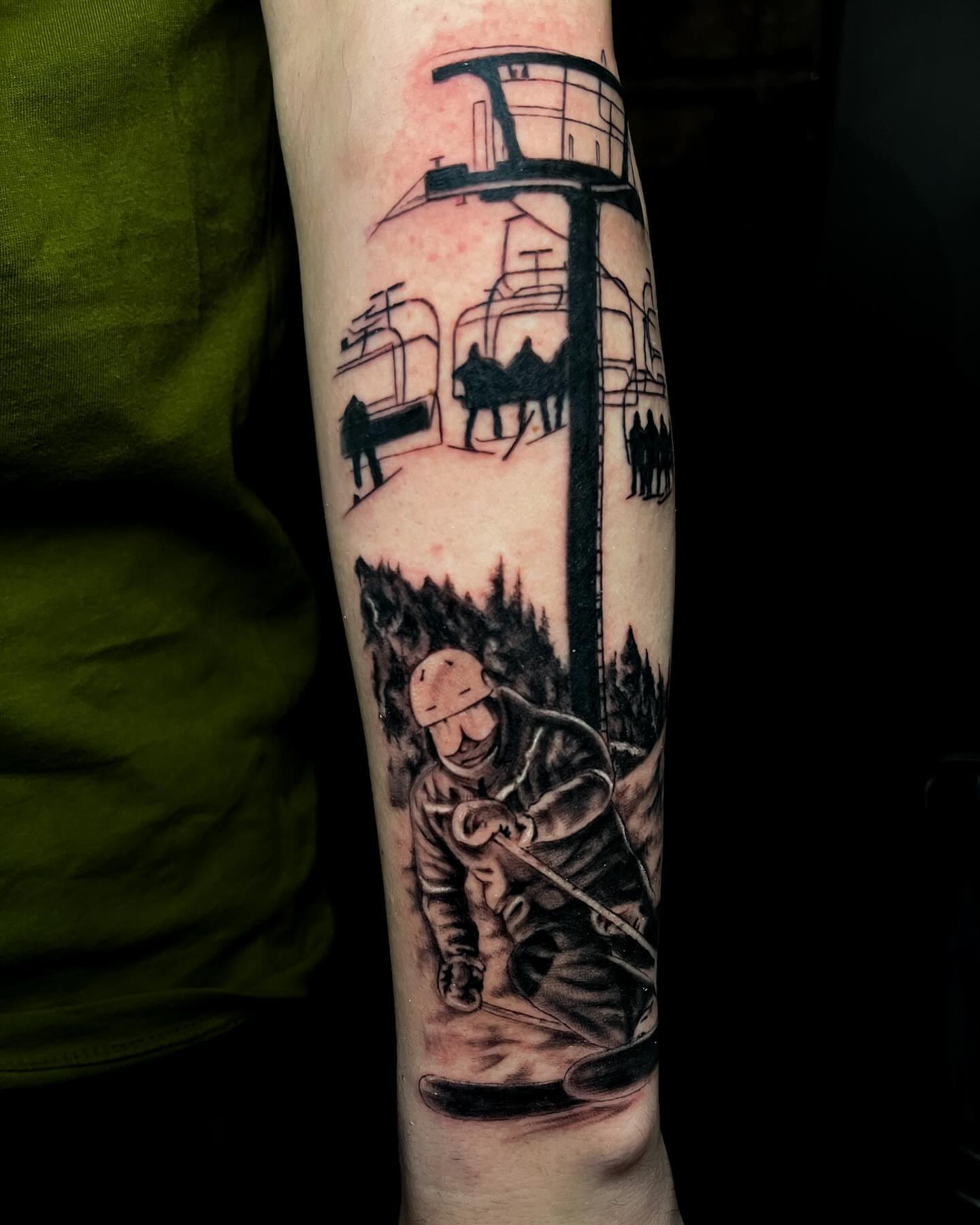 Ski lift and skier realism tattoo on the forearm by Demi DiMartino