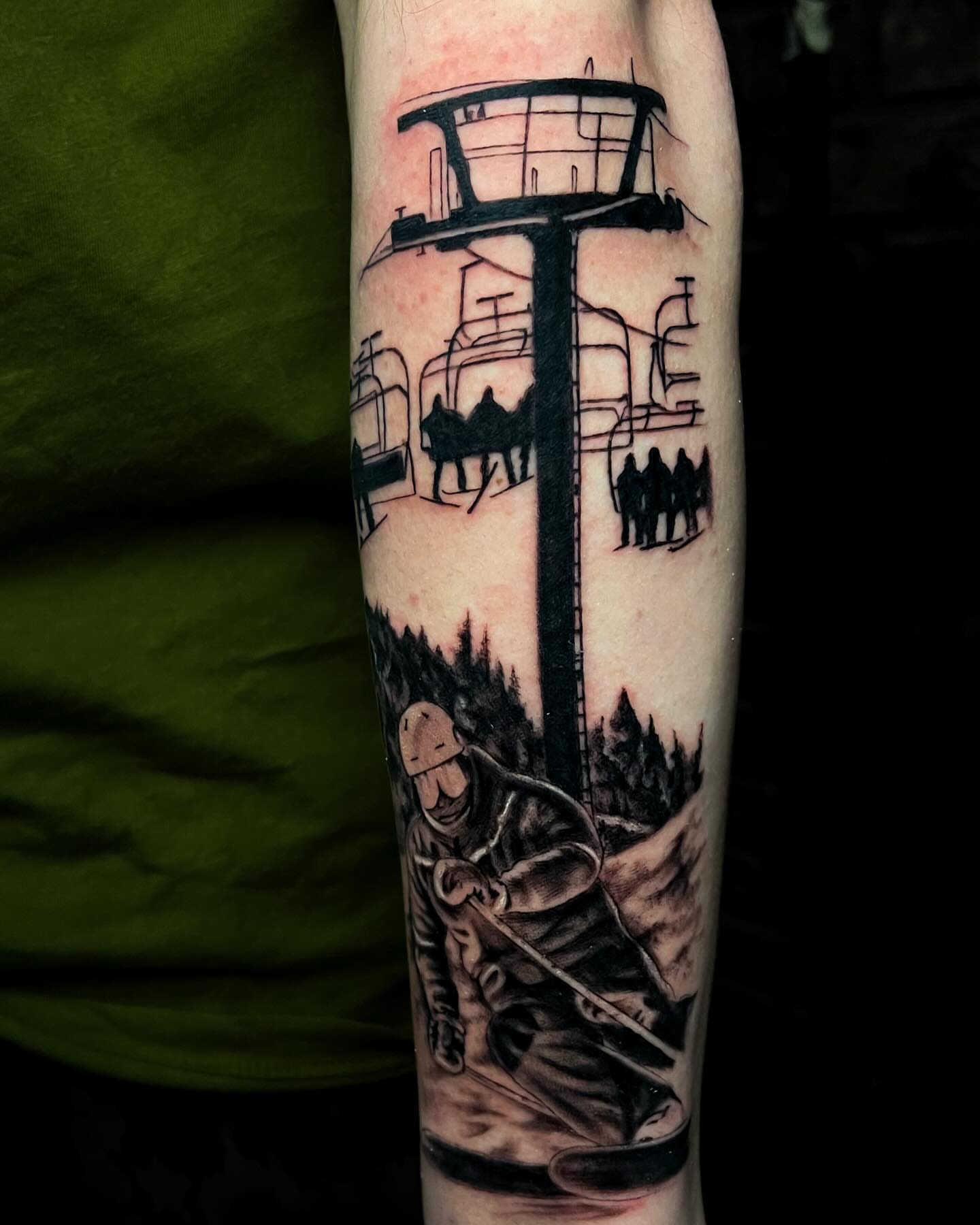 Ski lift and skier realism tattoo on the forearm by Demi DiMartino