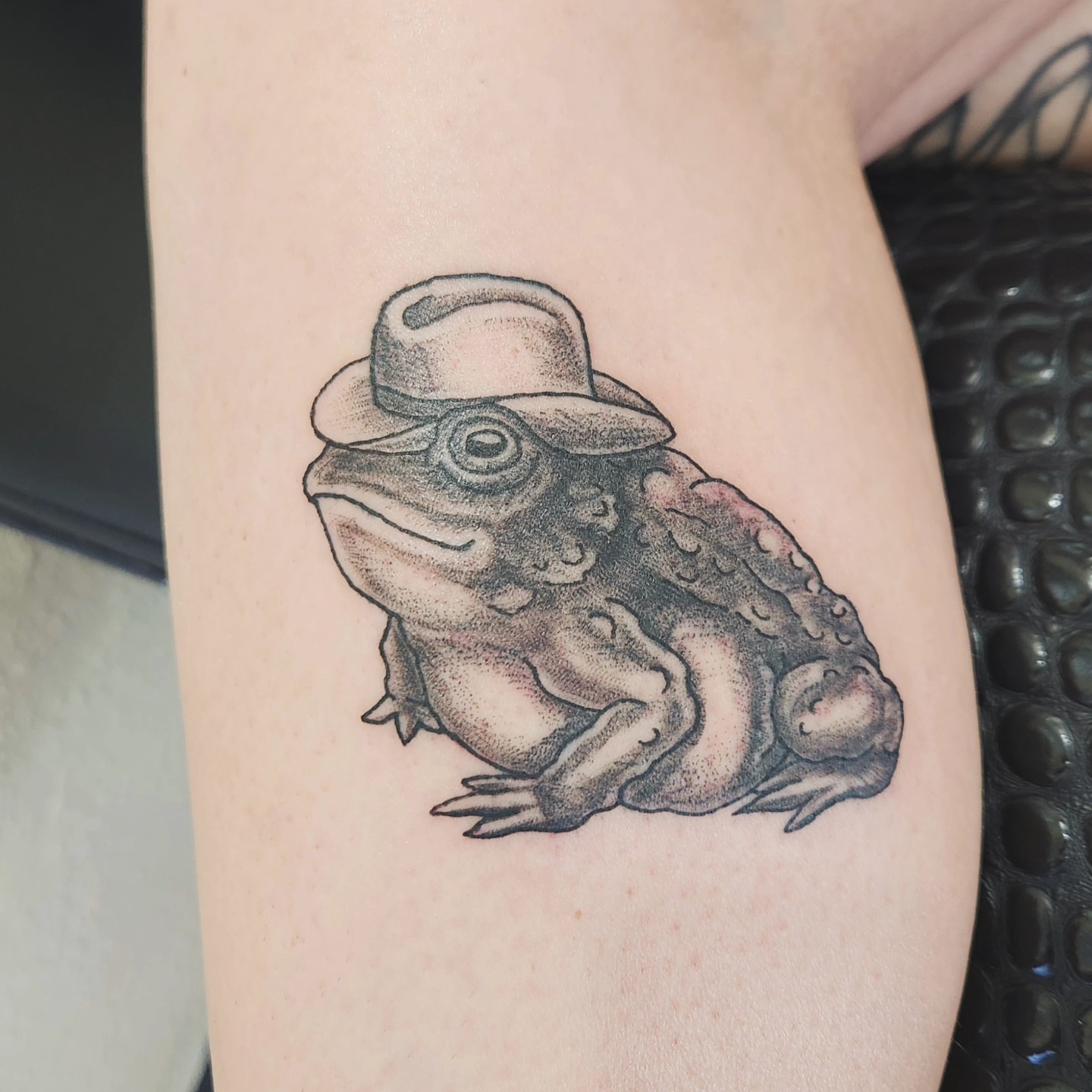Frog wearing a hat dotwork tattoo on the forearm by Perry