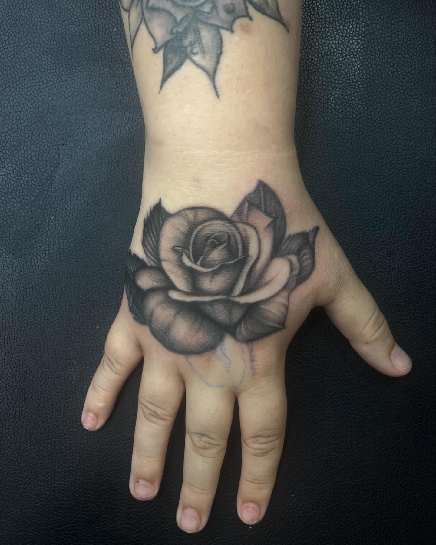 Rose black and grey tattoo on the hand by Alexa Camacho