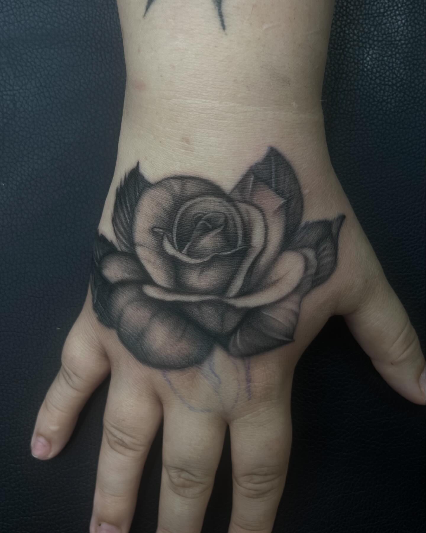 Rose black and grey tattoo on the hand by Alexa Camacho