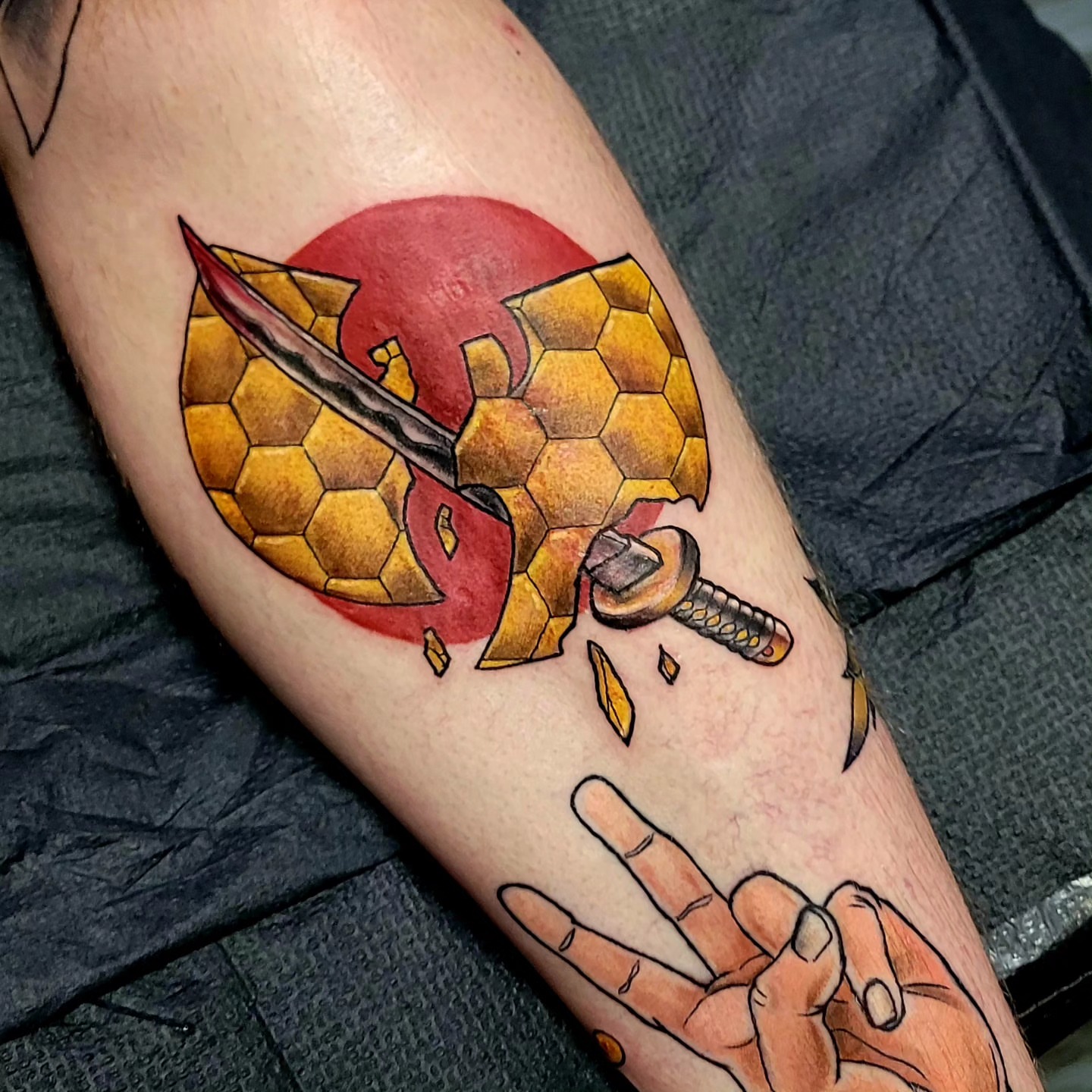 Honeycomb shield and sword geometric tattoo on the forearm by Dawne Michele