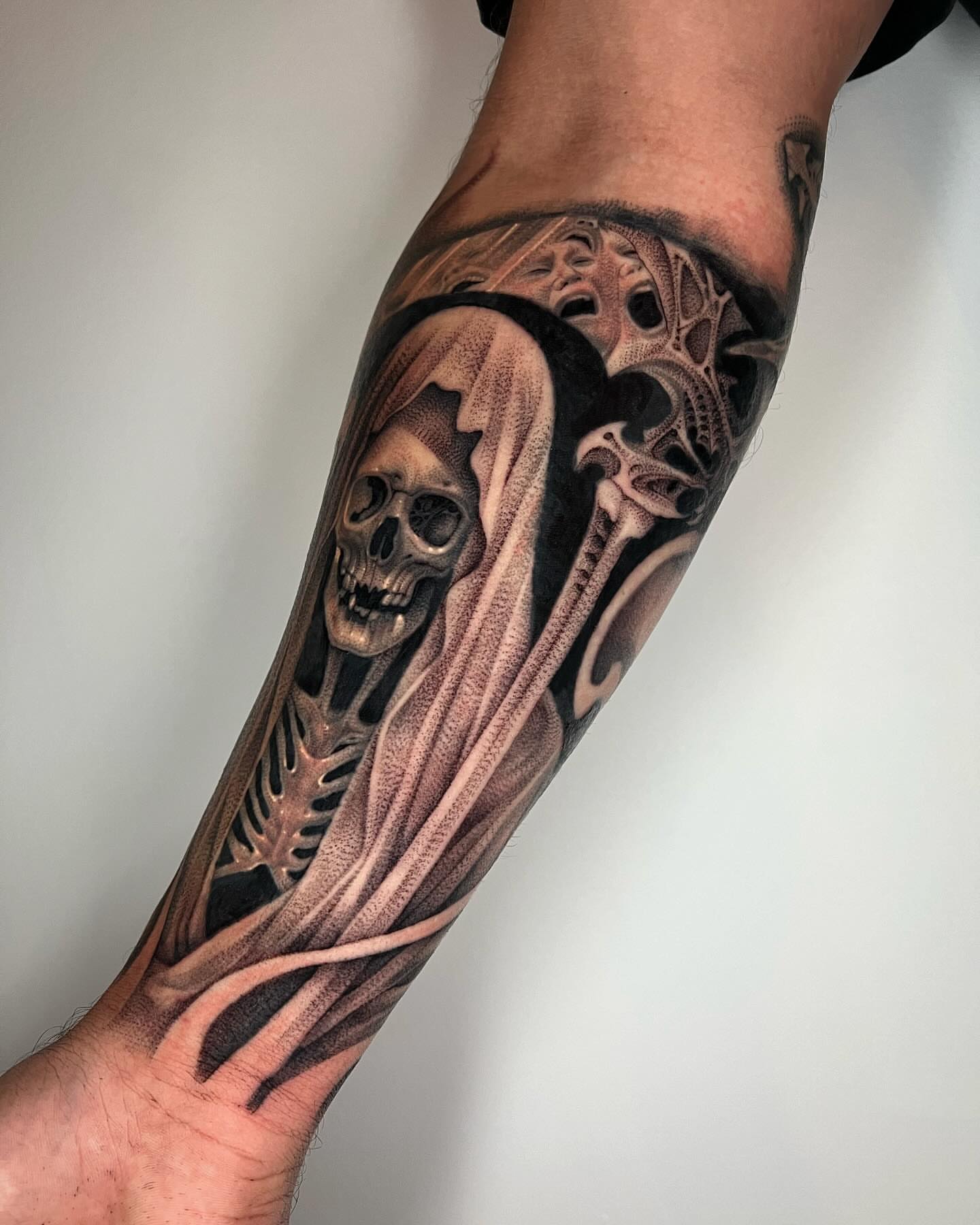 Skull and ghostly figure realism tattoo on the forearm by ๐ค ๐๐๐๐๐๐ ๐ค