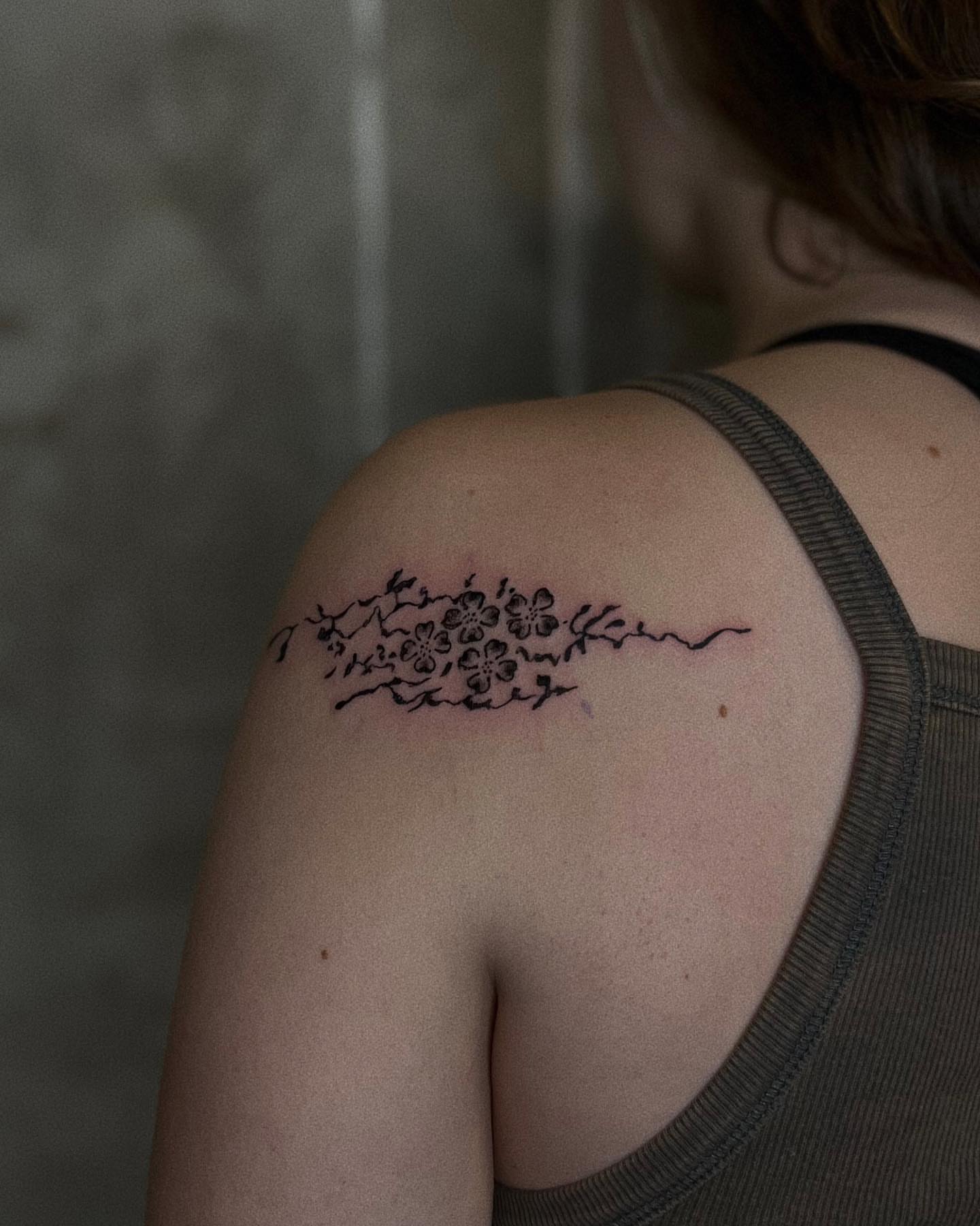Cherry blossom branch black and grey tattoo on the shoulder by San Kang