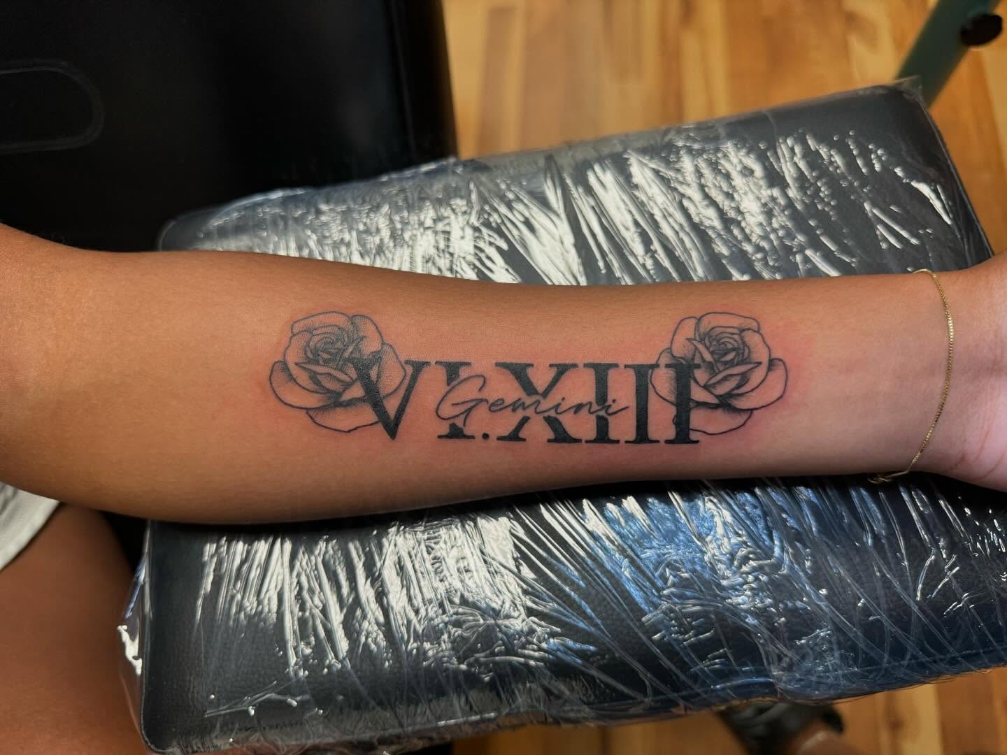 Roman numerals with roses black and grey tattoo on the forearm by Breanna💉🔮, Dover, Delaware