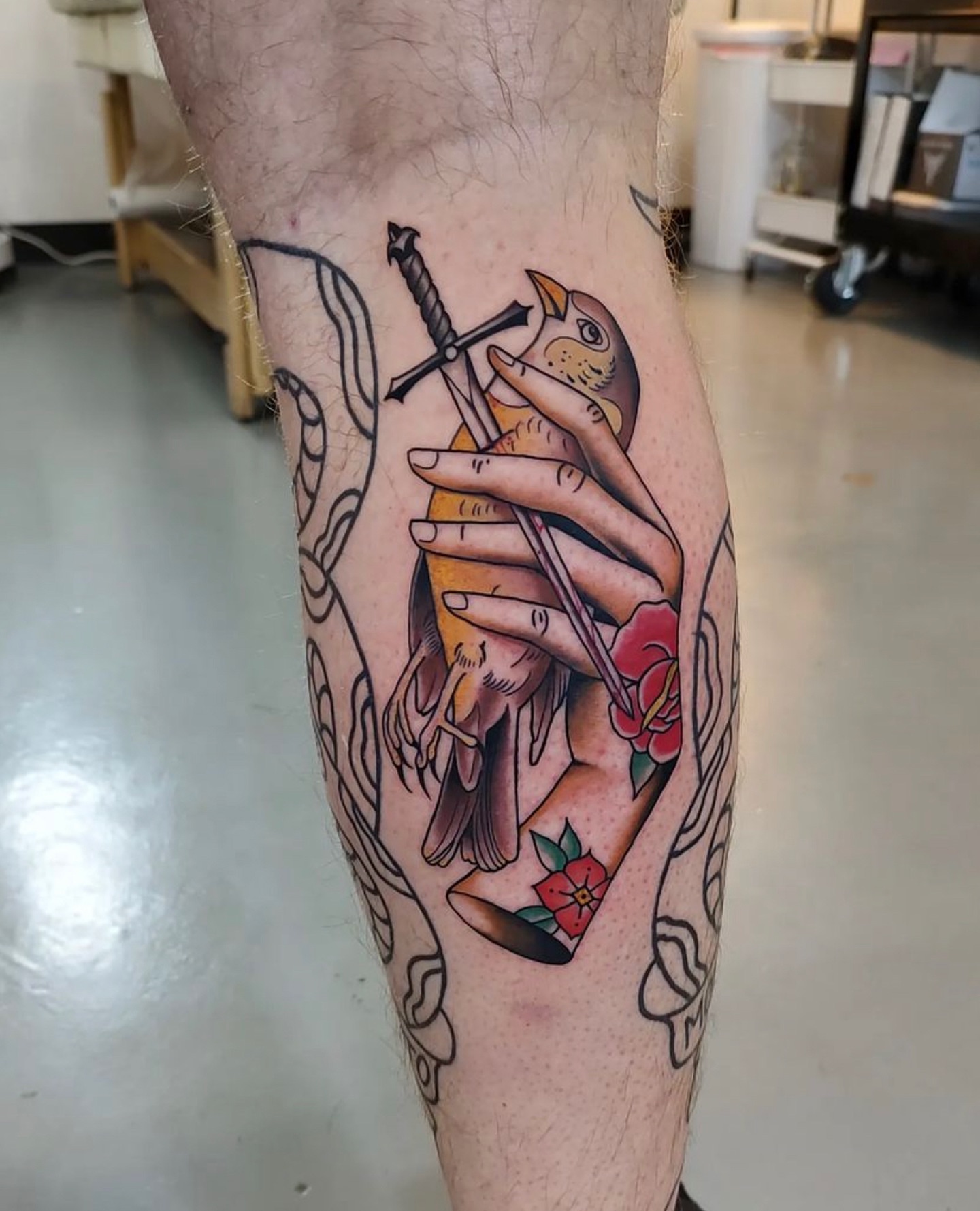 Bird and sword American traditional tattoo on the calf by Herc