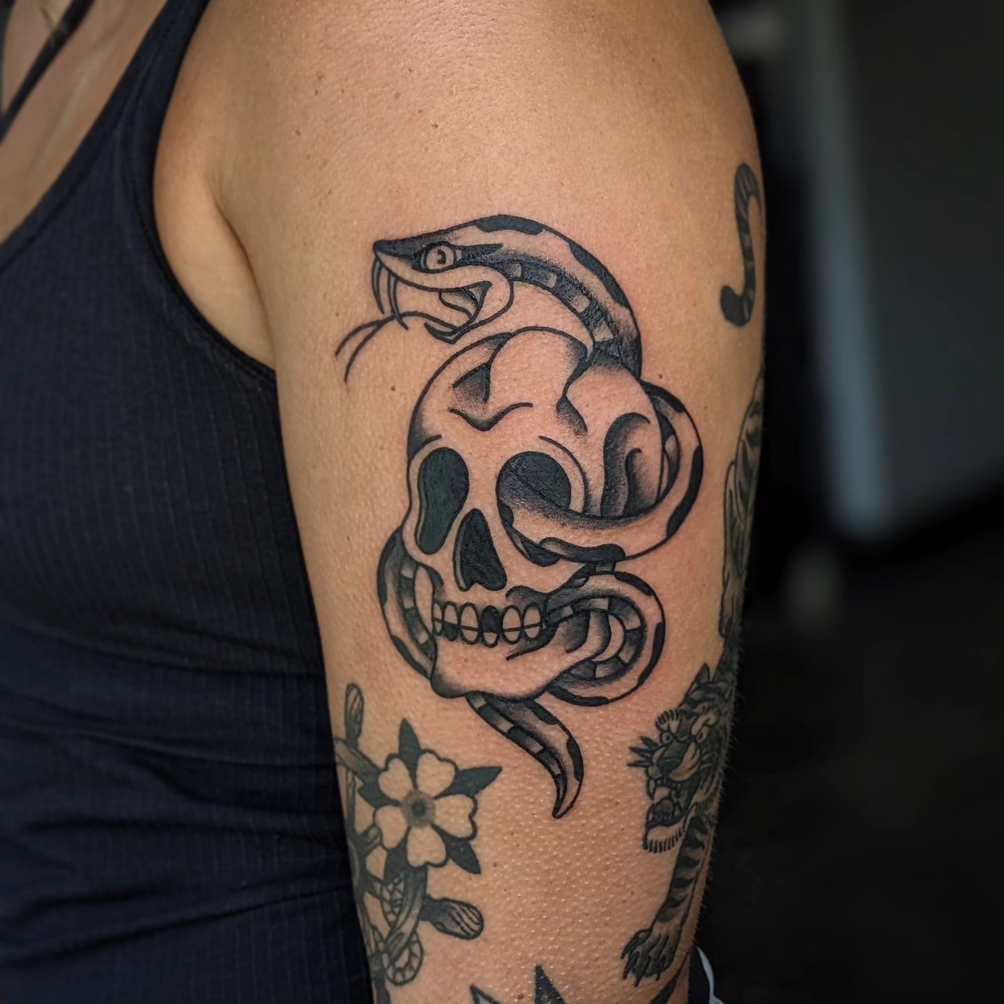 Snake and skull black and grey tattoo on the forearm by Joe McElravy