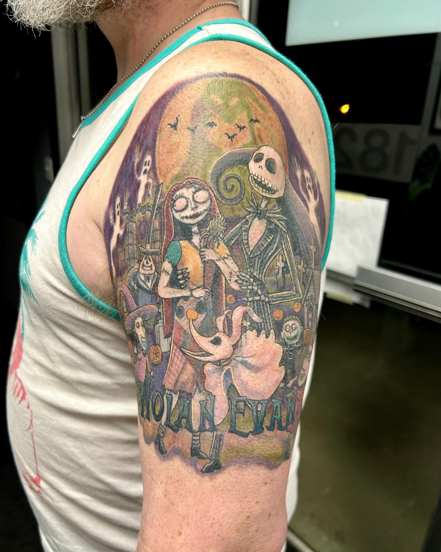 The Nightmare Before Christmas characters illustrative tattoo on the upper arm by B Hendrix, Cuyahoga Falls, Ohio