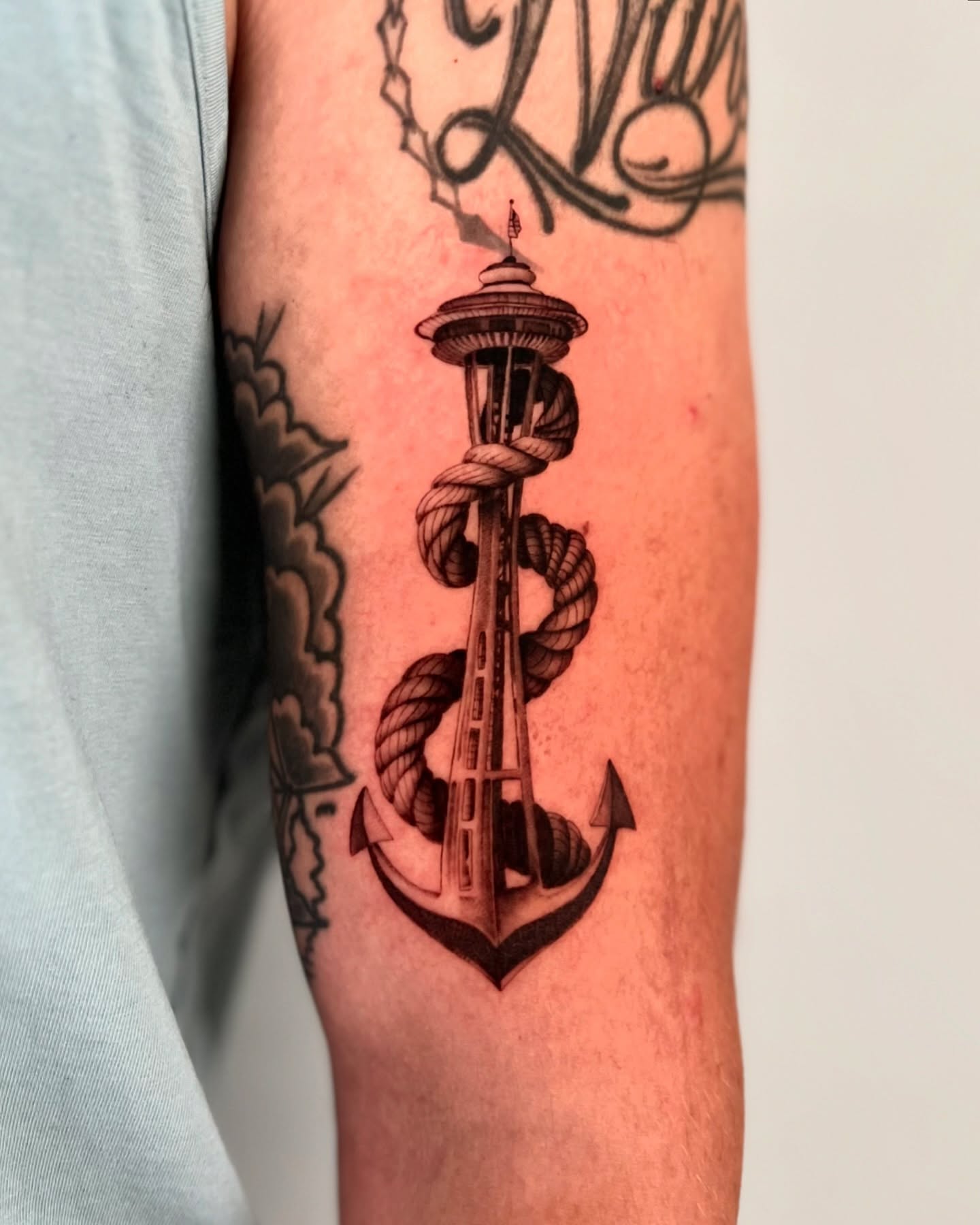 Space needle anchor black and grey tattoo on the forearm by dom