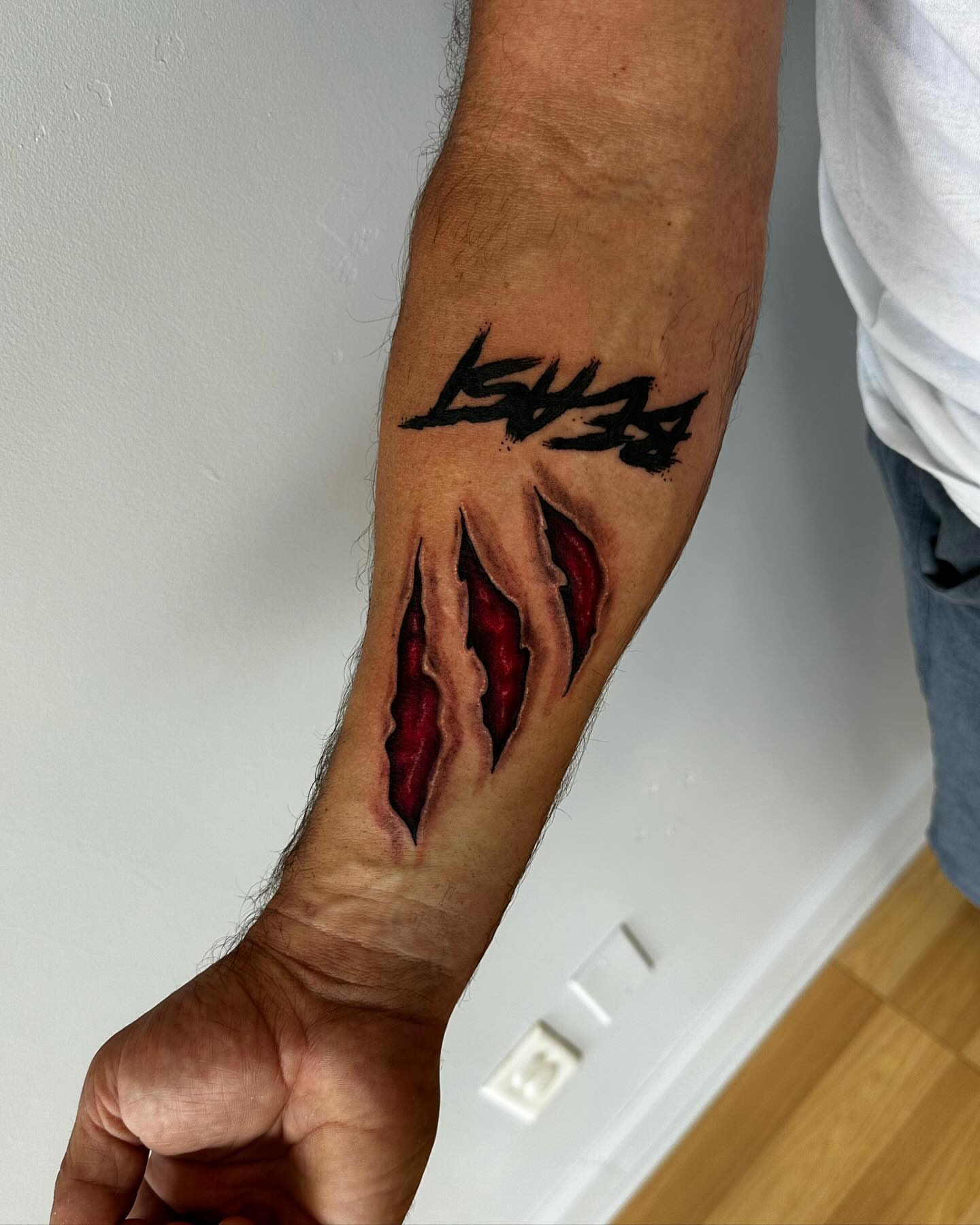 Ripped skin realism tattoo on the forearm by Emma