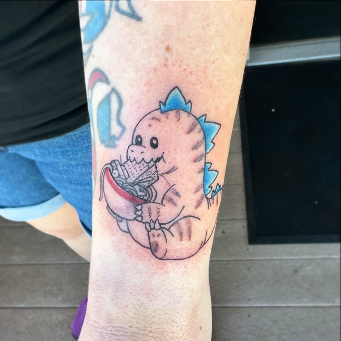 Baby dinosaur new school tattoo on the forearm by manda, Lebanon, Ohio