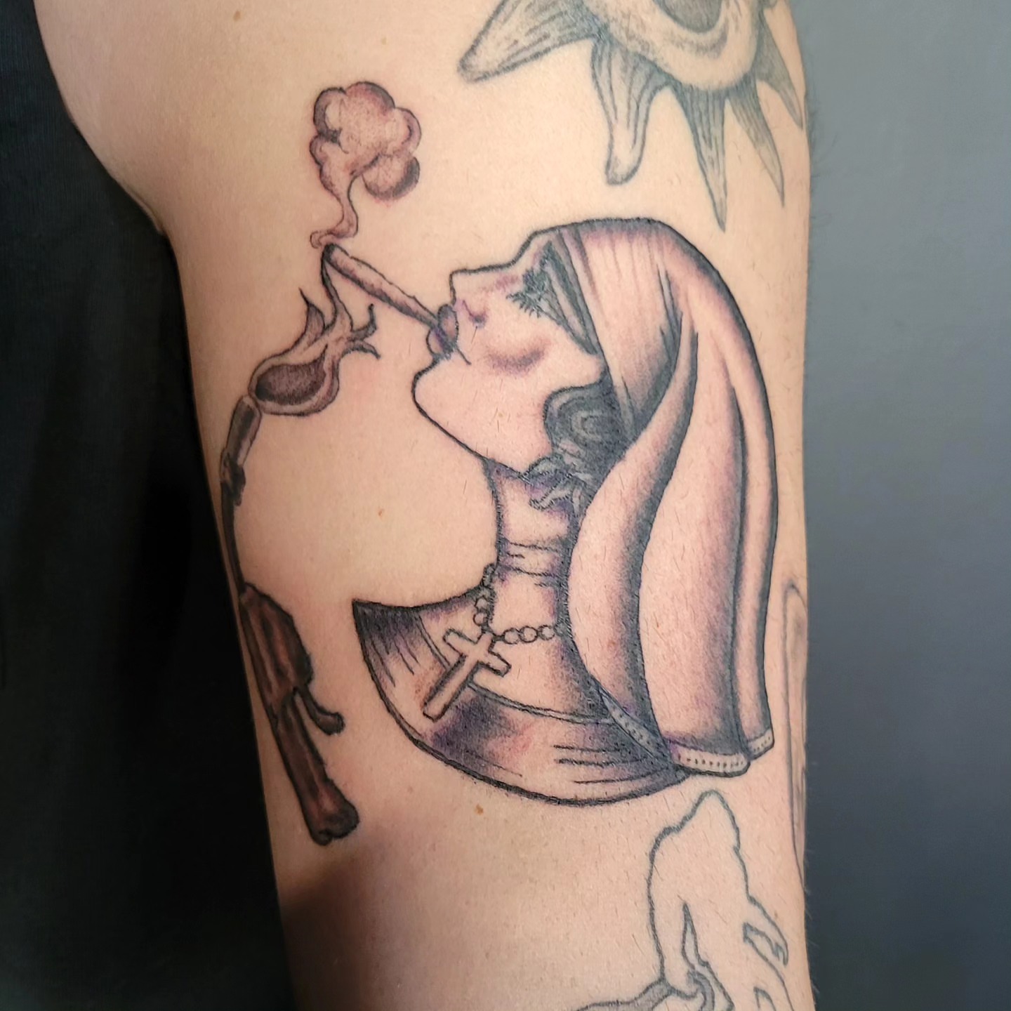 Nun smoking black and grey tattoo on the forearm by Tim Andrews