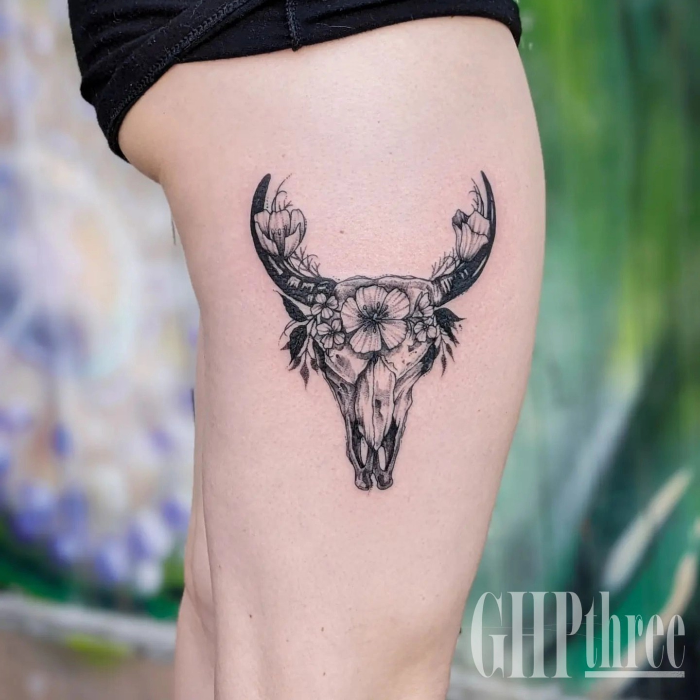 Bull skull with flowers realism tattoo on the thigh by Gail Howard Perry III