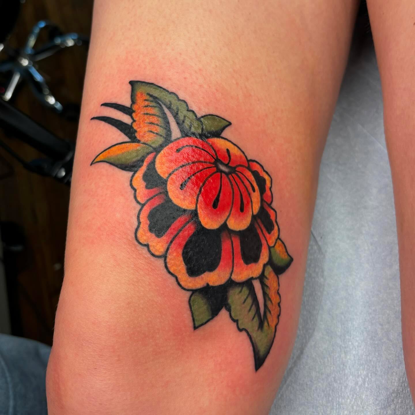 Flower American traditional tattoo on the forearm by Emmy Gallagher