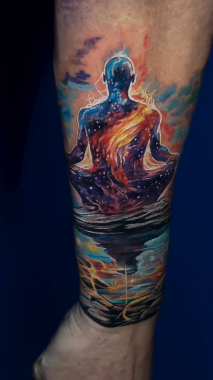 Meditating figure in space realism tattoo by James Moyer