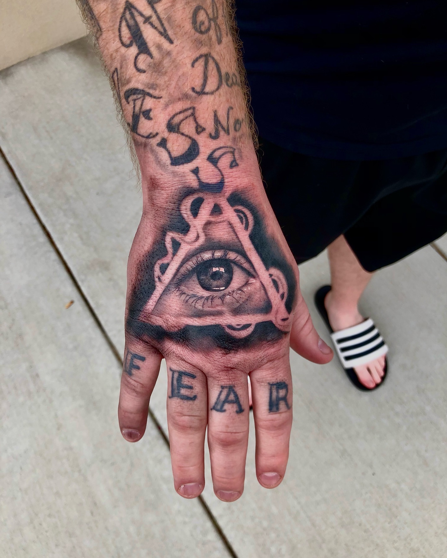 Eye and pyramid geometric tattoo on the hand by Ian Chancellor, Leighton Buzzard, England
