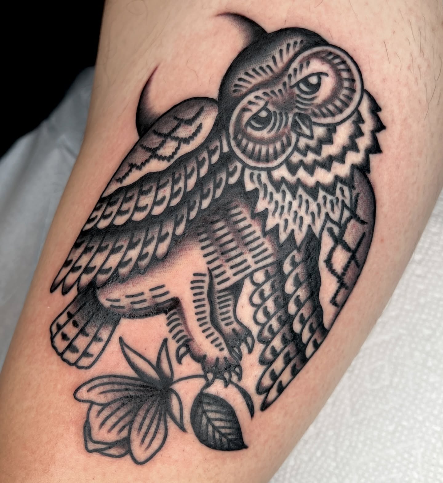 Owl black and grey tattoo on the forearm by Ian Jett