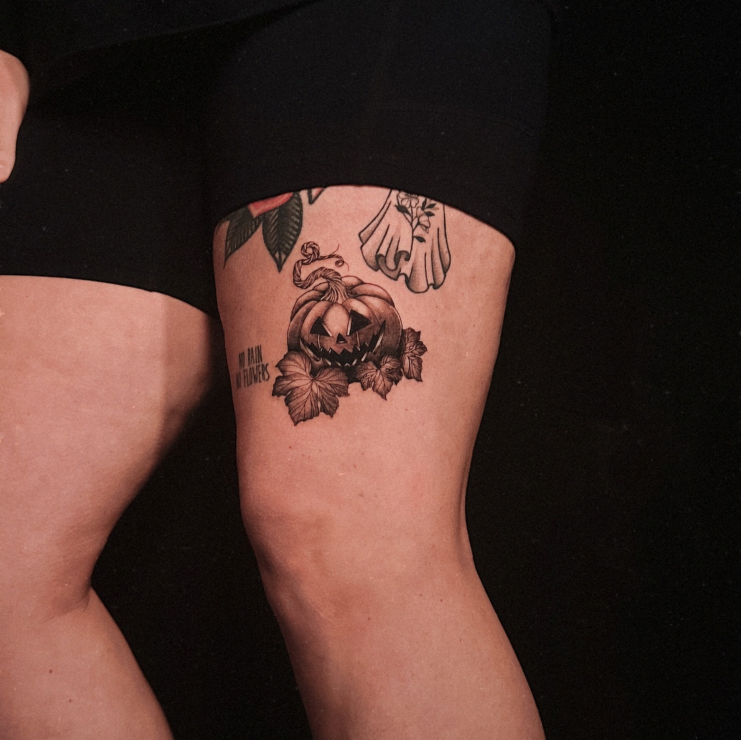 Pumpkin black and grey tattoo on the thigh by Kelsey Zussman