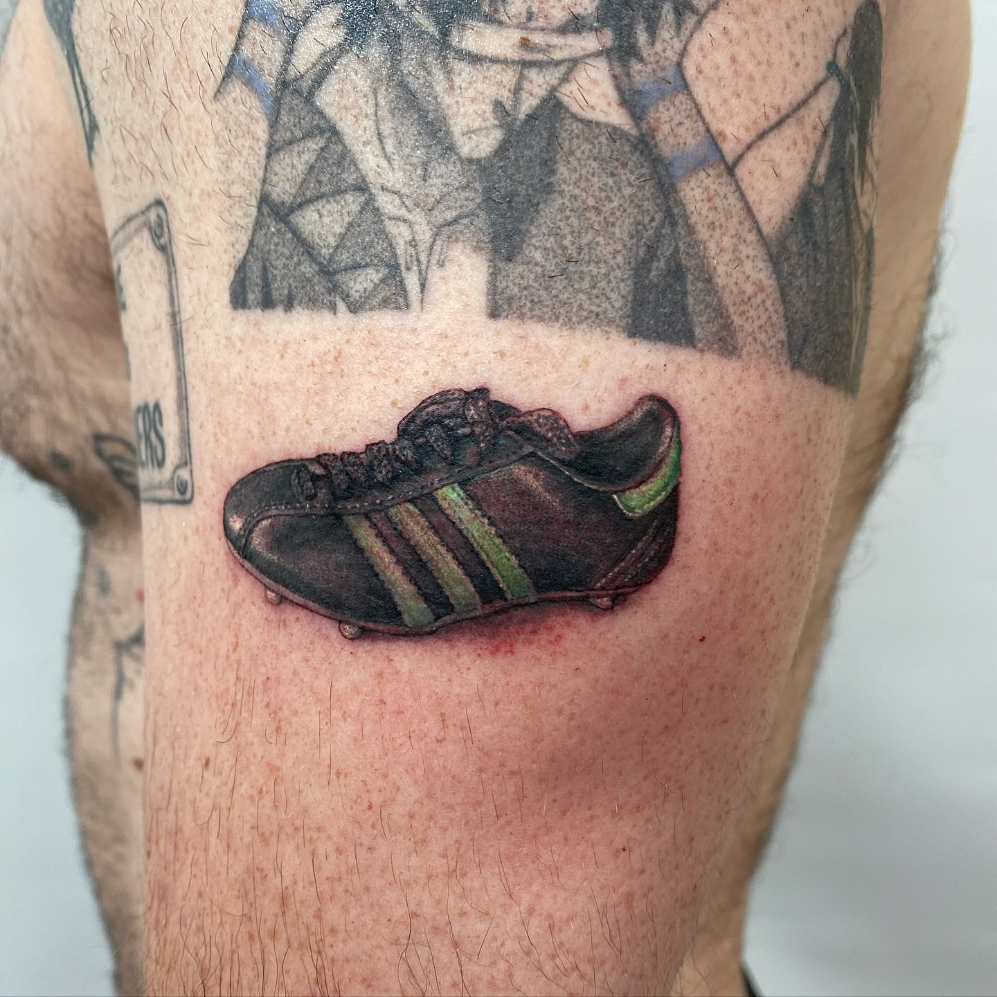Football boot realism tattoo on the leg by Joey Delarosa, San Francisco, California