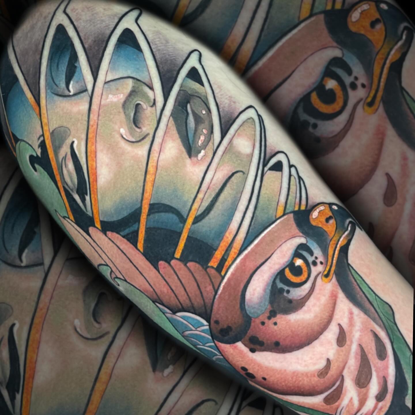 Fish and lotus American traditional tattoo on the forearm by Nathan Mickle