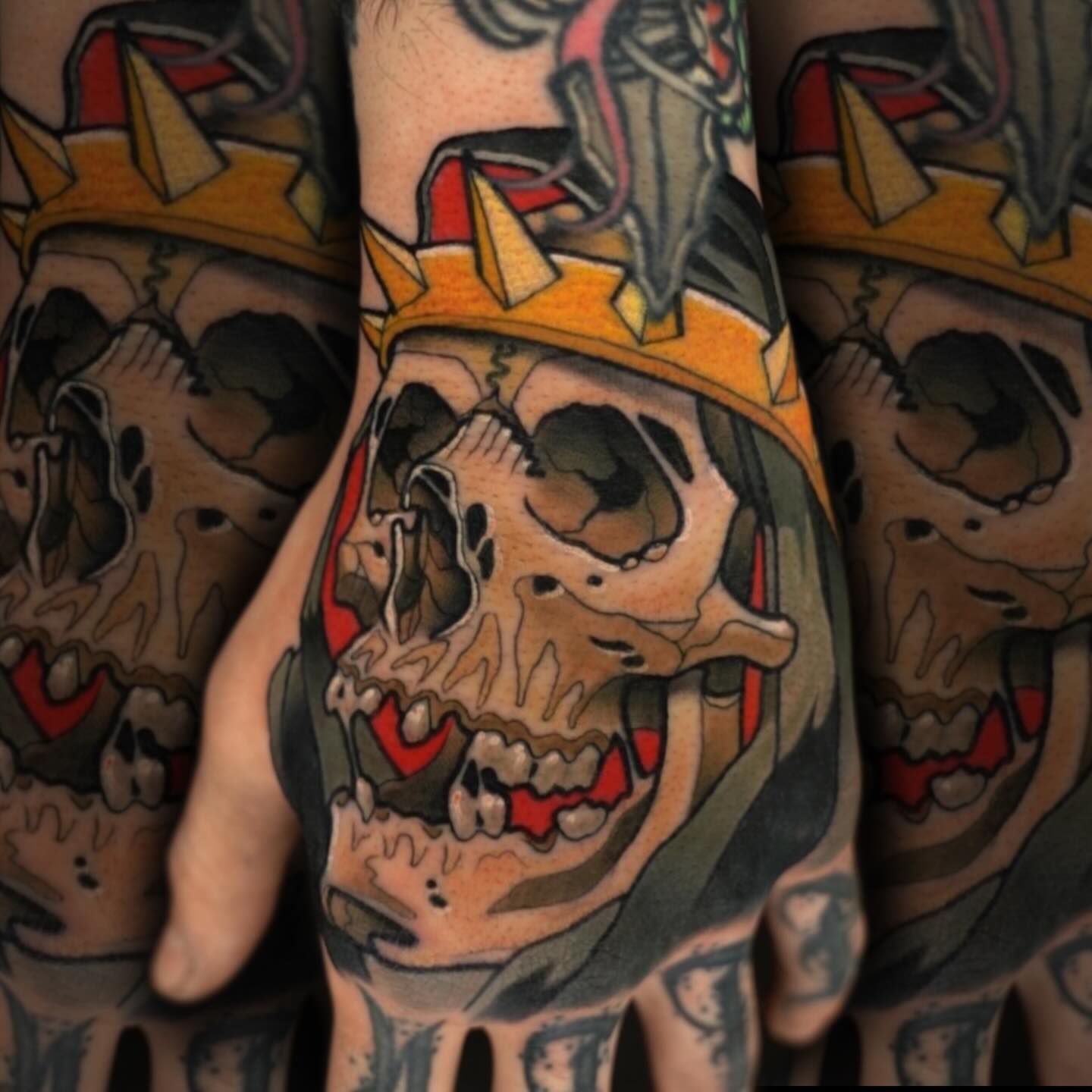 Grinning skull wearing crown American traditional tattoo on the forearm by Nathan Mickle