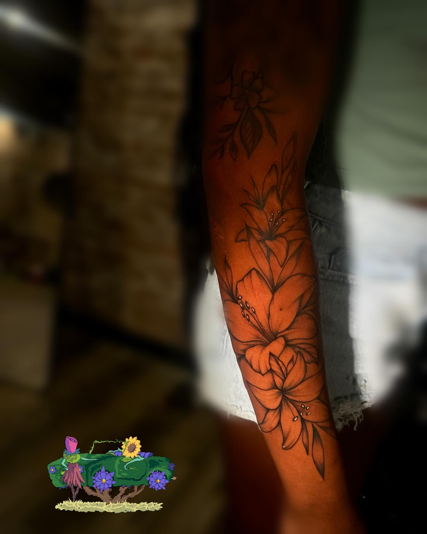 Lilies black and grey tattoo on the forearm by Marques Neal