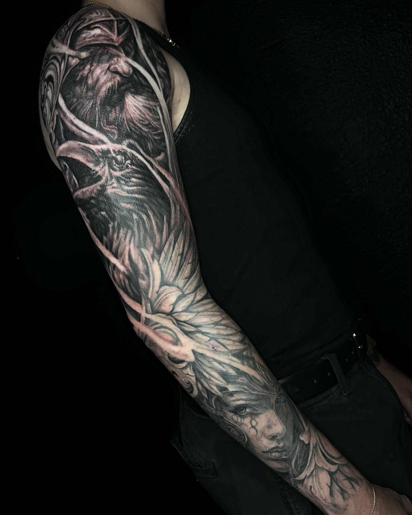 Raven and woman realism tattoo on the upper arm by Alia