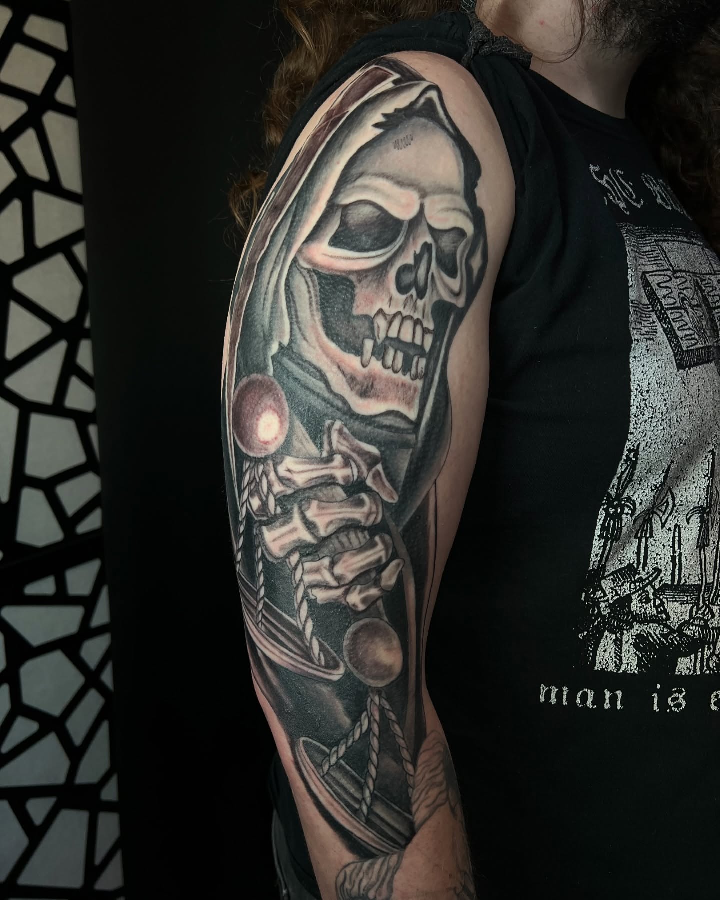Reaper realism tattoo on the upper arm by Daphne Landry