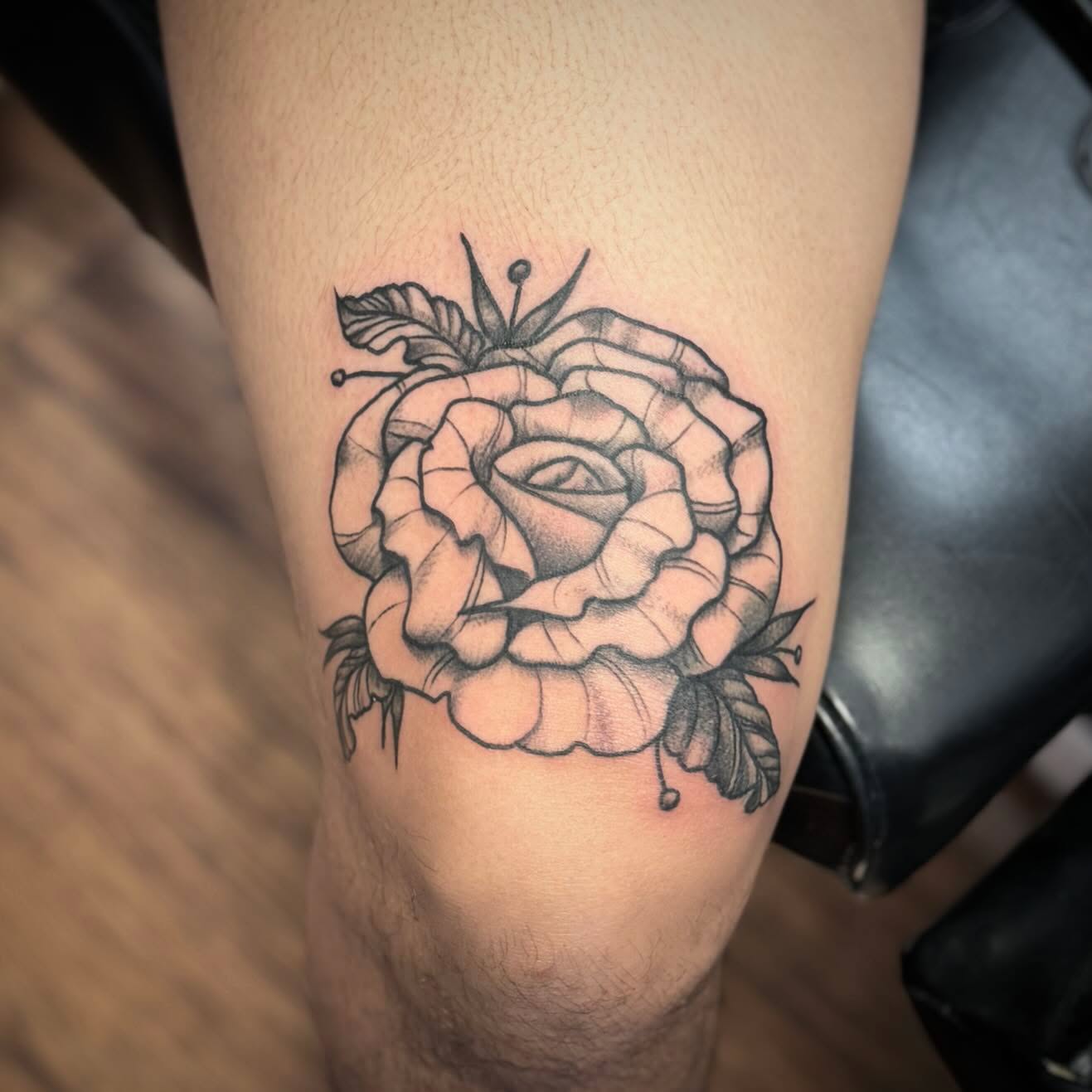 Rose black and grey tattoo on the thigh by Kyle J. Bishop