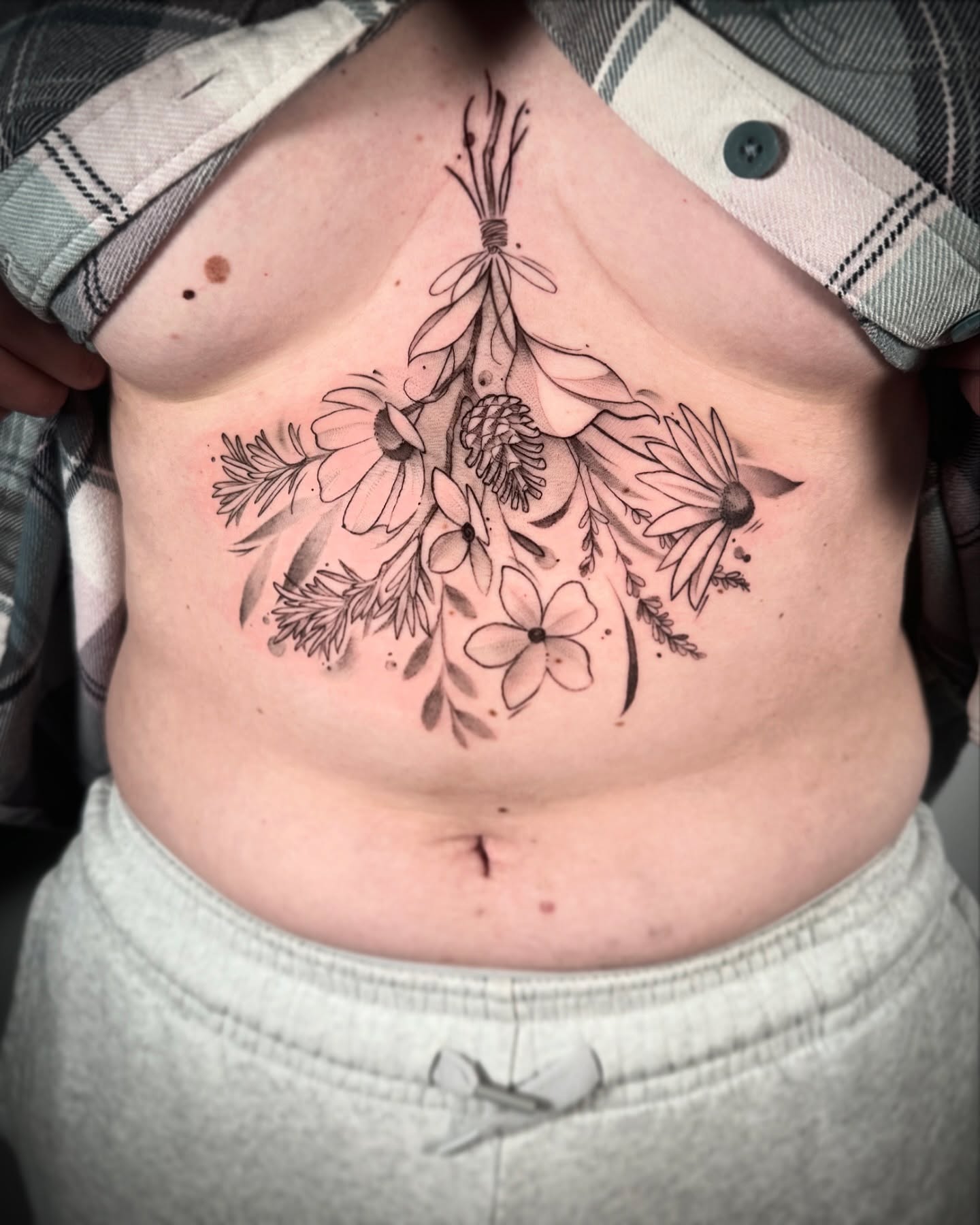 Floral bouquet black and grey tattoo on the torso by Stephanie Shortsleeve