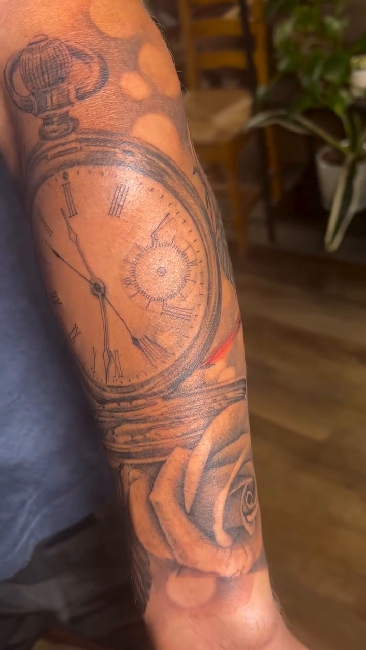 Pocket watch, rose, and cardinal realism tattoo by Sam Minter, Grafton, Massachusetts