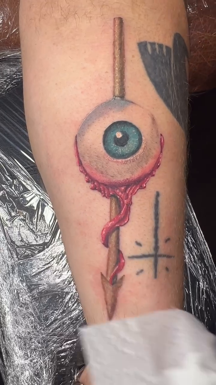 Eye with arrow and cross dark realism tattoo by Neeko