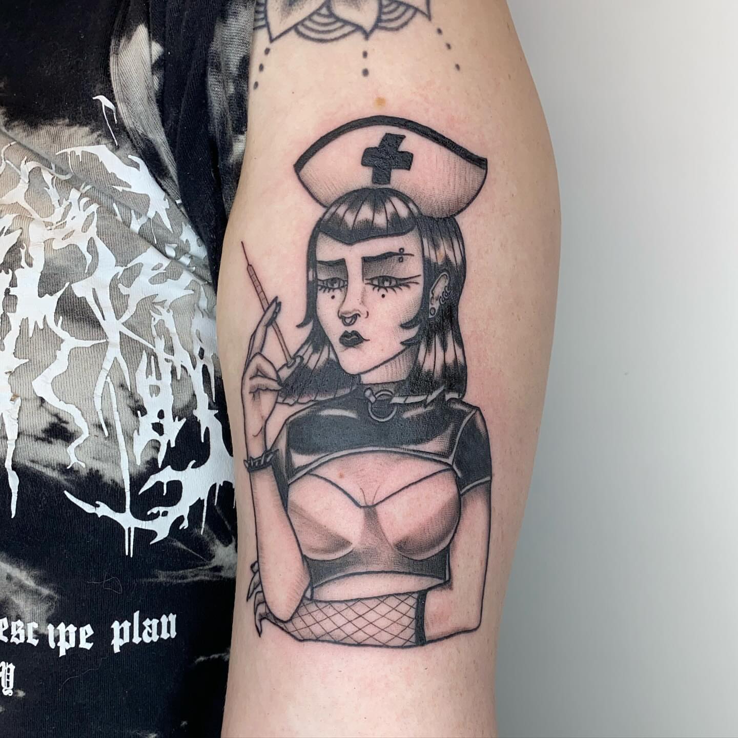 Nurse with syringe black and grey tattoo on the forearm by Amber Lea, Kansas City, Kansas