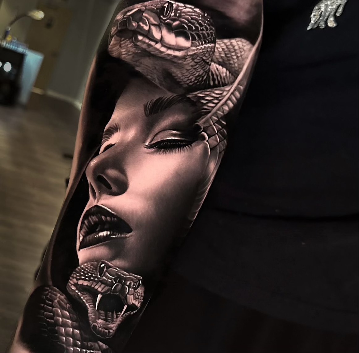 Woman with snakes realism tattoo on the upper arm by Kasey Gonzalez, Bel Air, Maryland